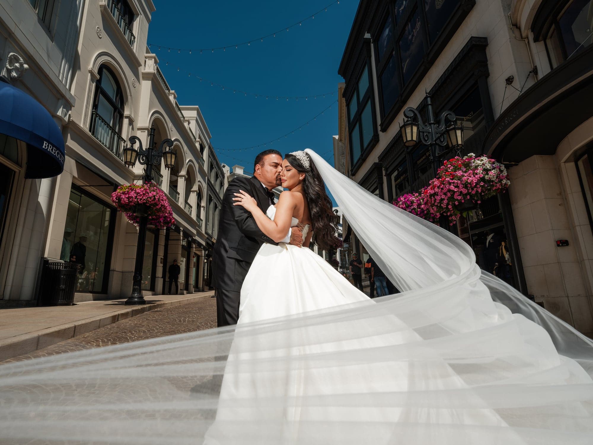 Ghazal and her groom sharing a city portrait between tall Beverly Hills buildings