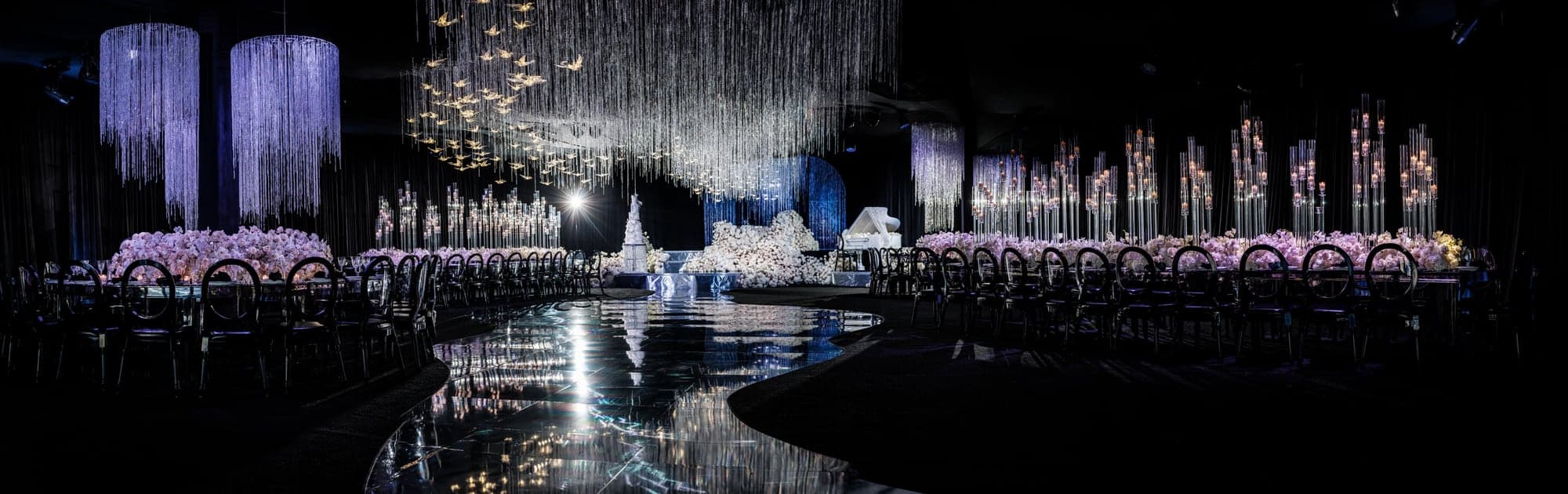 Suspended crystals and white floral structures filling the Beverly Hilton ballroom
