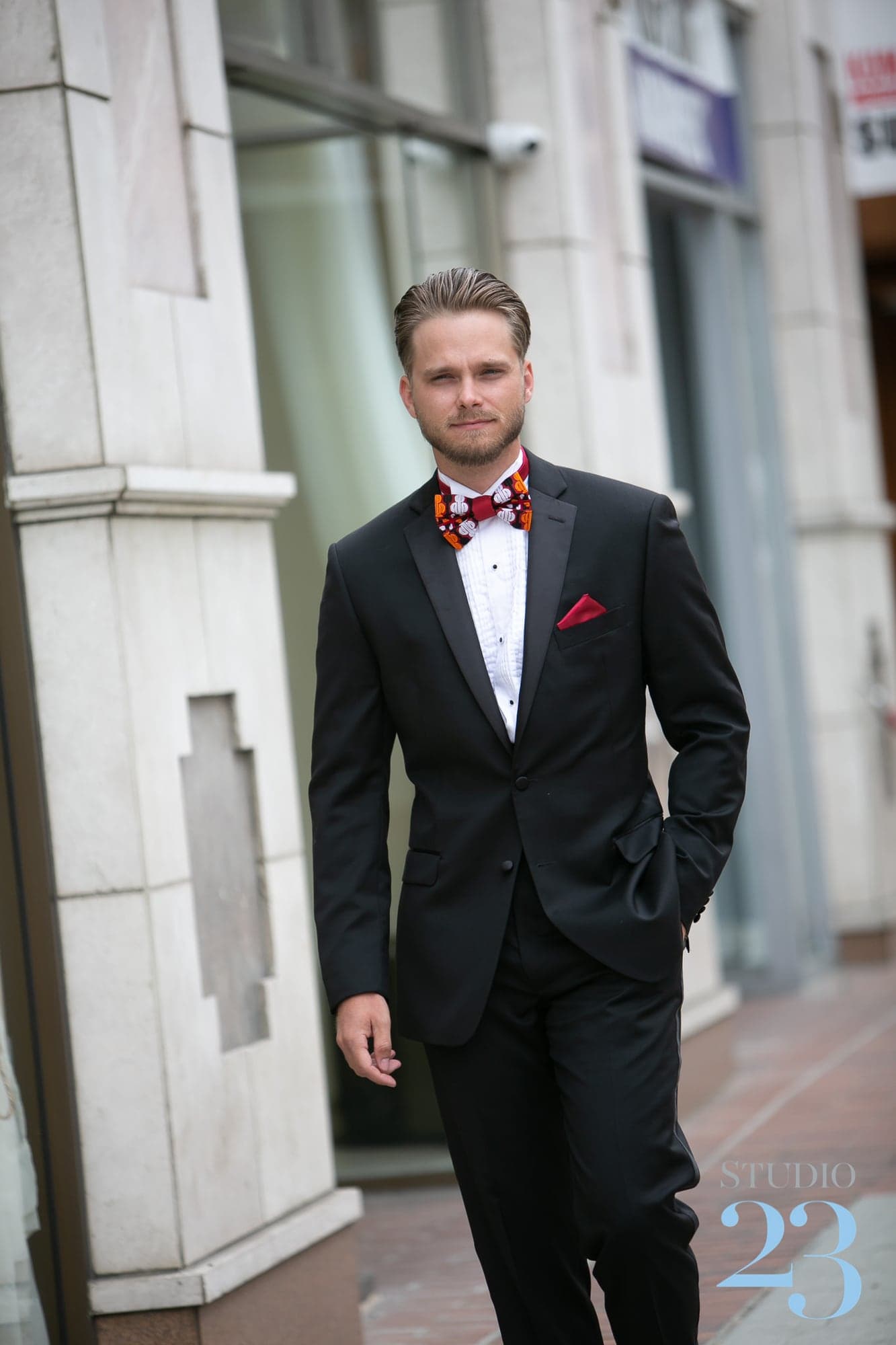 Cameron in a black suit with a patterned bow tie