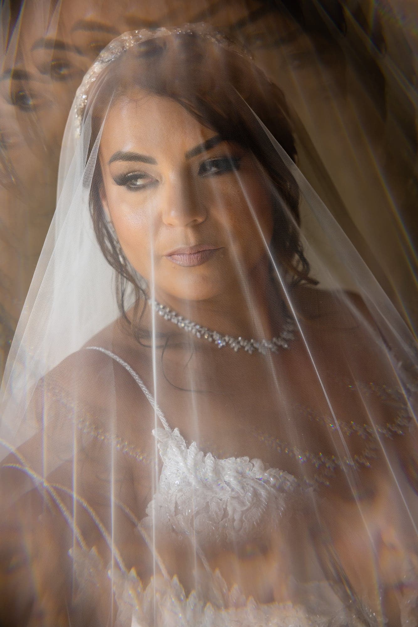 Mazl looking through her veil before walking to the Calamigos Ranch ceremony