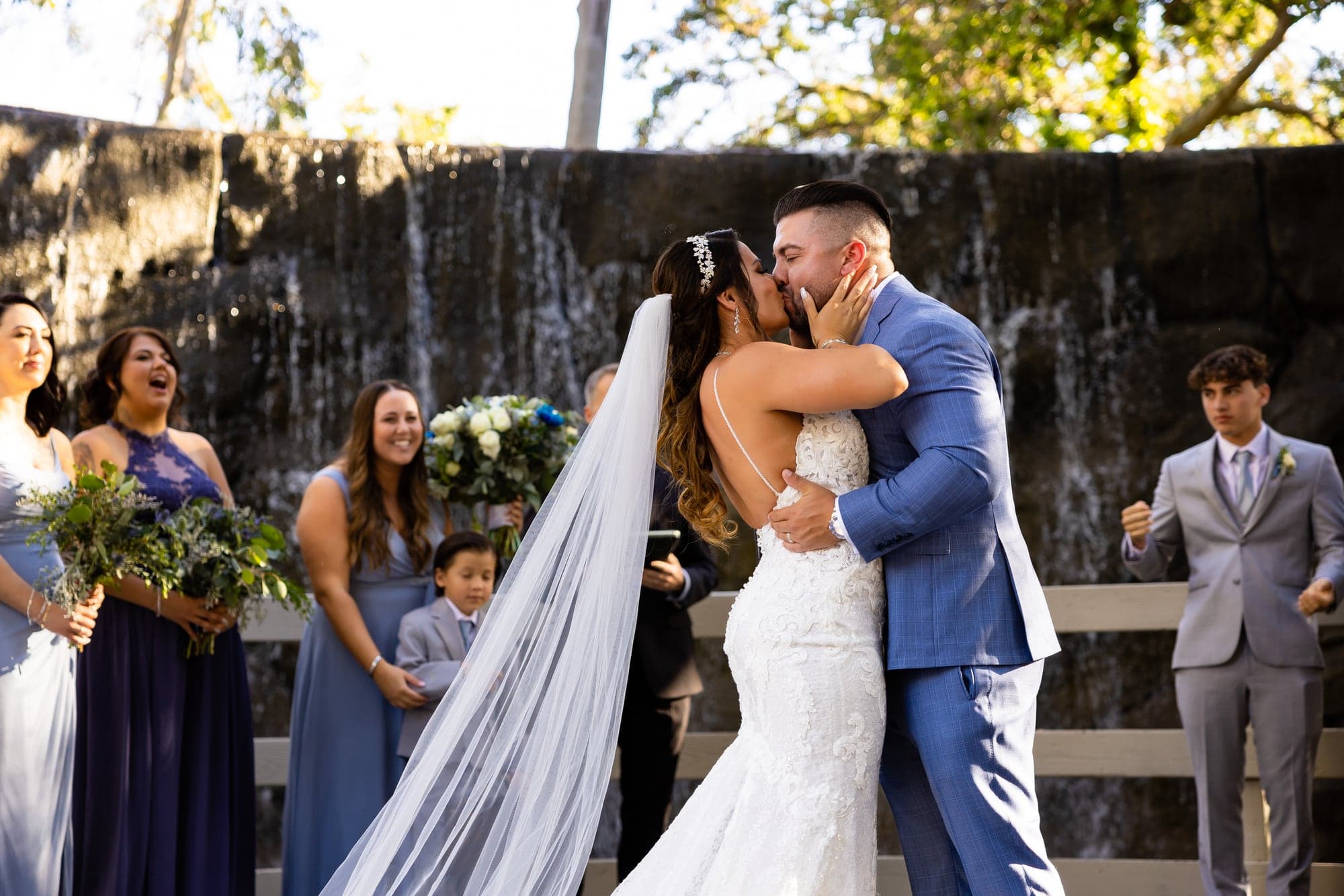 Arthur and Mazl embracing beneath the trees immediately after their Oak Room ceremony