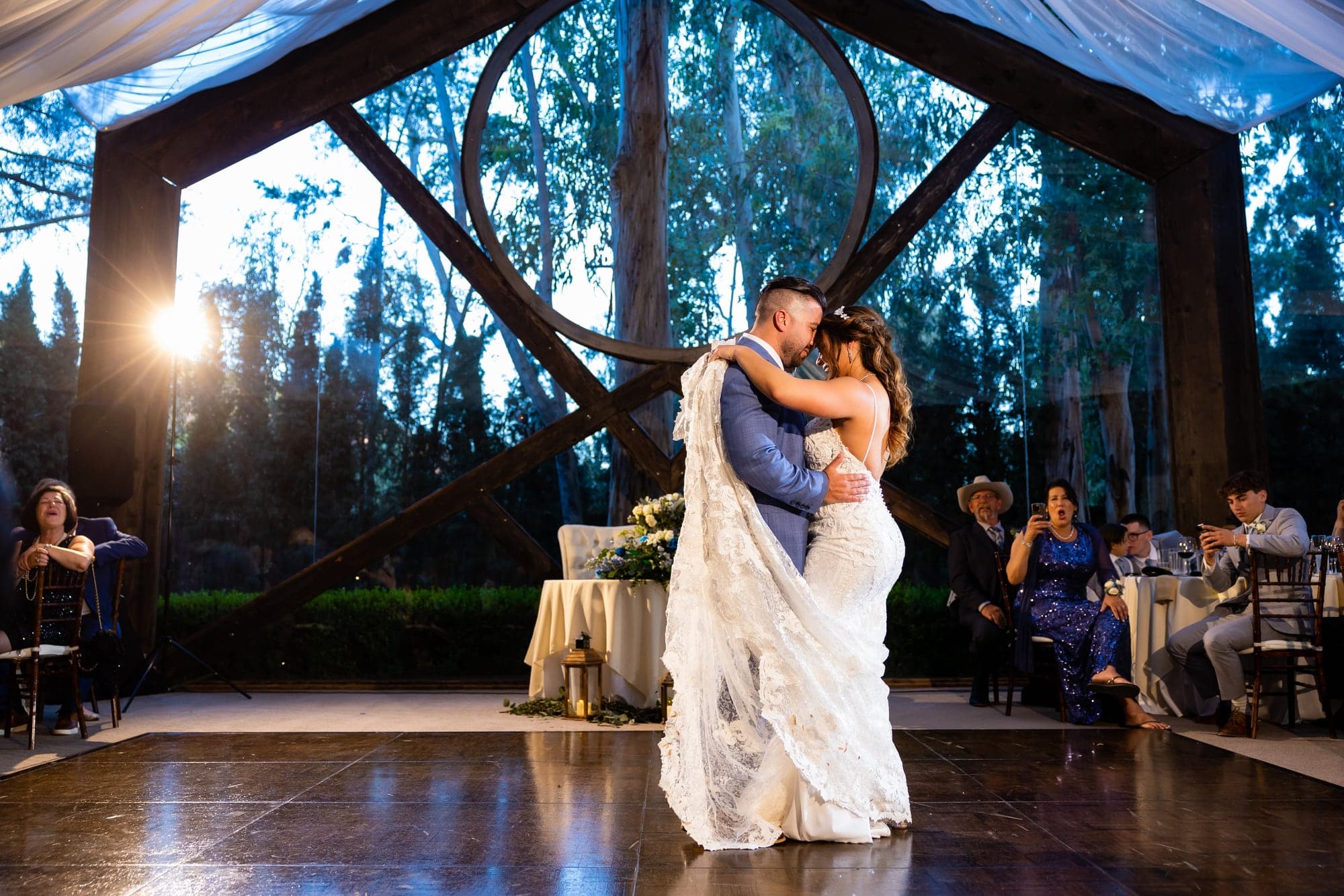 Arthur and Mazl sharing their first dance beneath the sculptural branches of the Oak Room