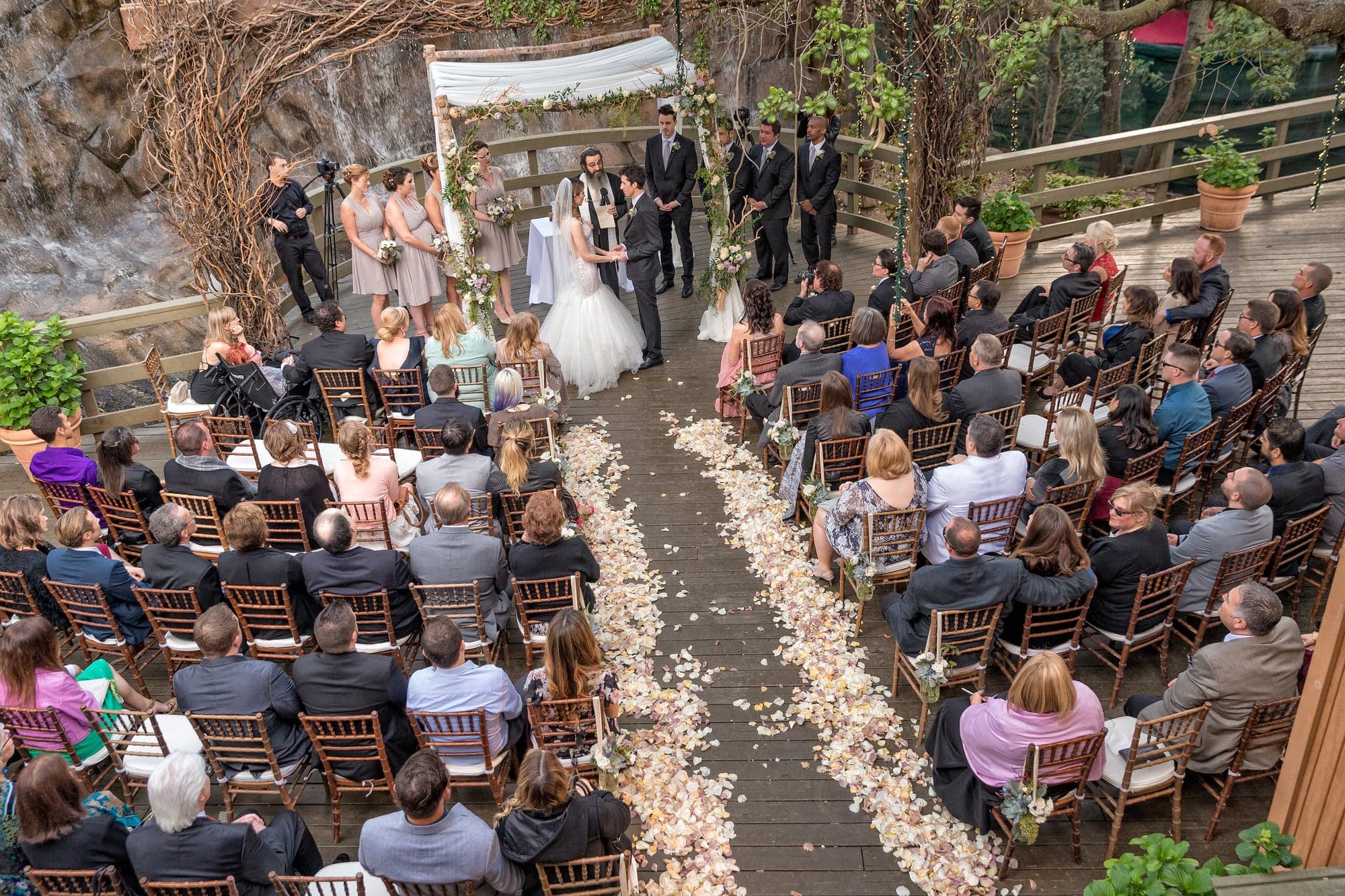 Outdoor wedding ceremony beneath the trees at Calamigos Ranch