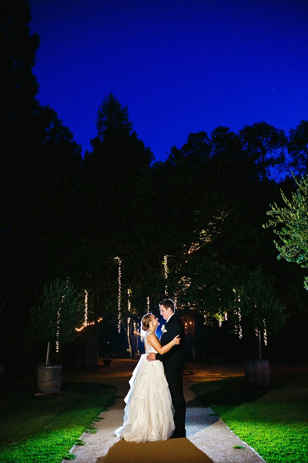 Night portrait of Kelly and John beneath the trees