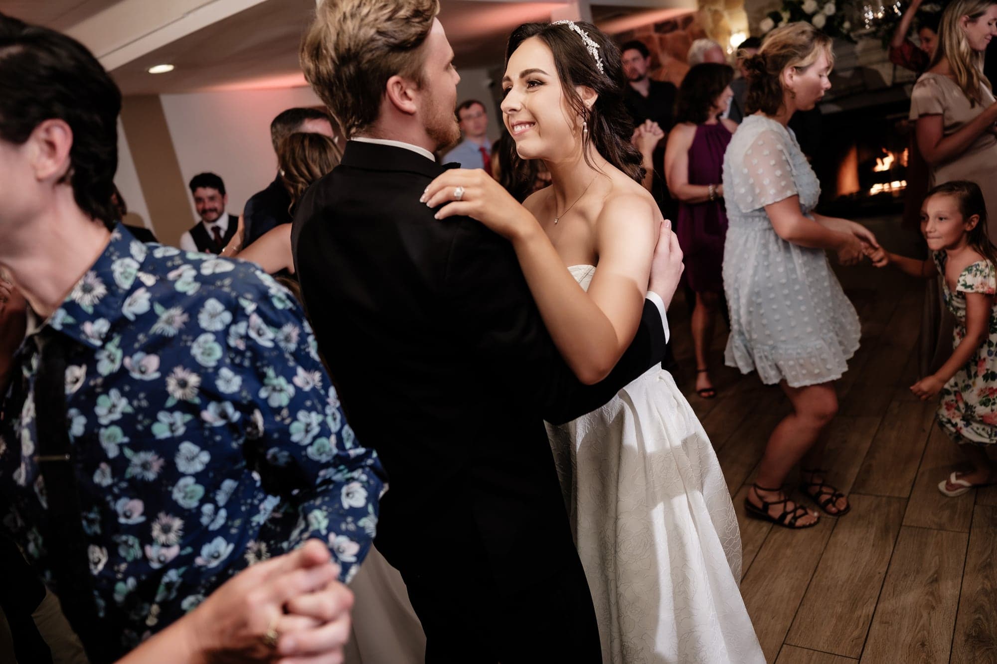 The newlyweds dancing with family and friends during the Birch Room reception
