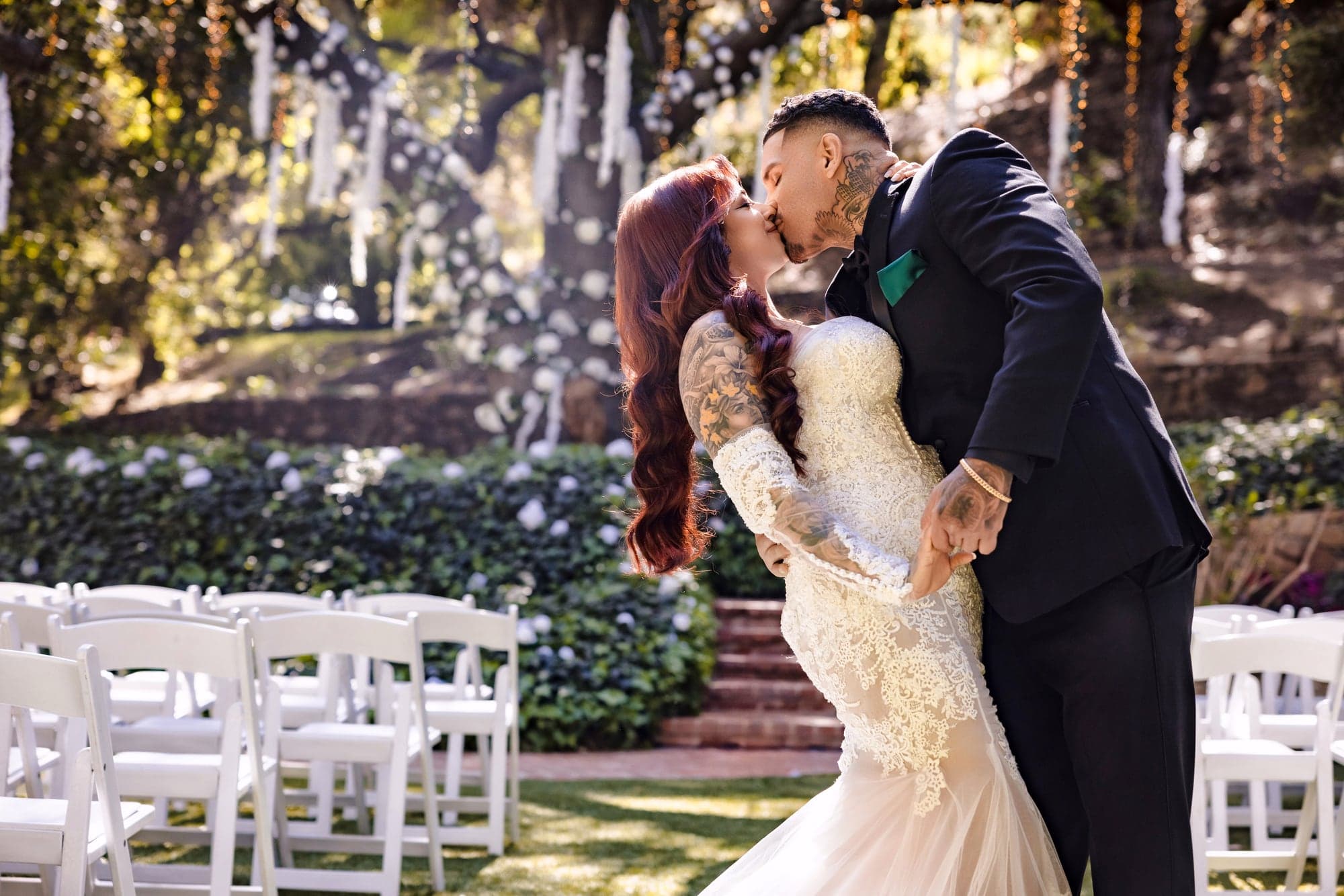 Gina and Alonso sharing a portrait beneath the oak canopy at Calamigos Ranch