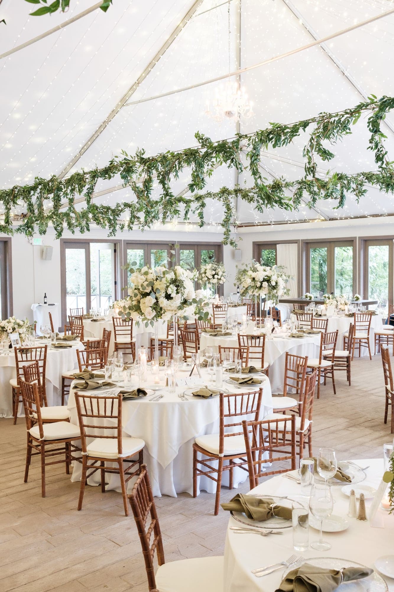 The airy Calamigos Ranch reception prepared with pale flowers, greenery, and long tables