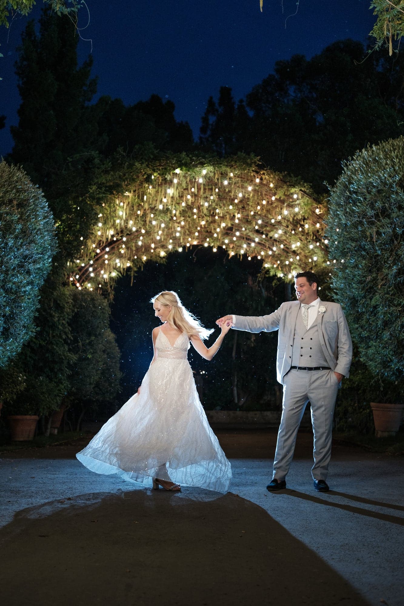 Karolina and Jonathan sharing a nighttime portrait beside the illuminated Ferris wheel at Calamigos Ranch, photographed by Michael Anthony Photography