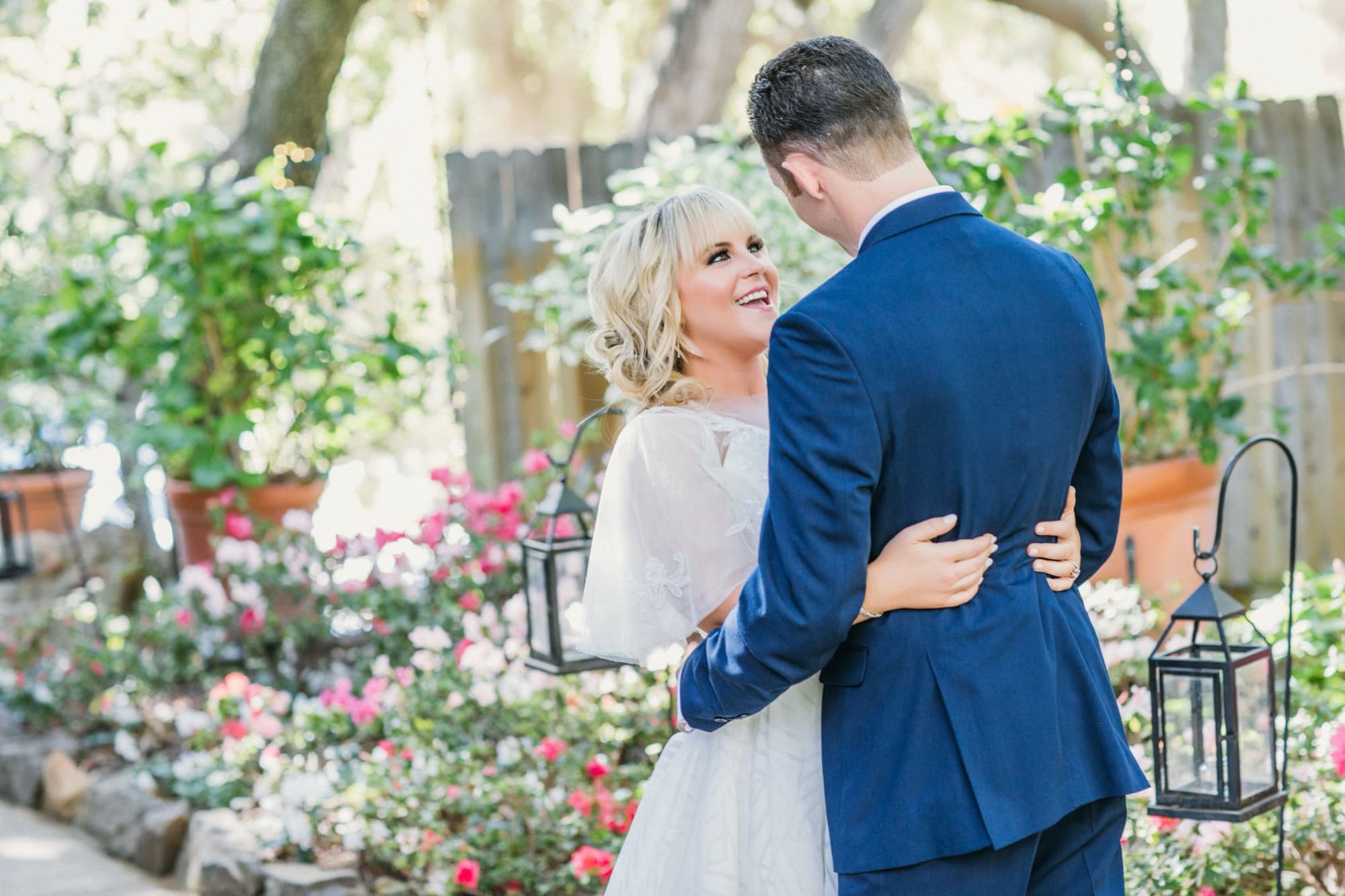 Bride and groom touching foreheads during their first look in the rose garden at Calamigos Ranch