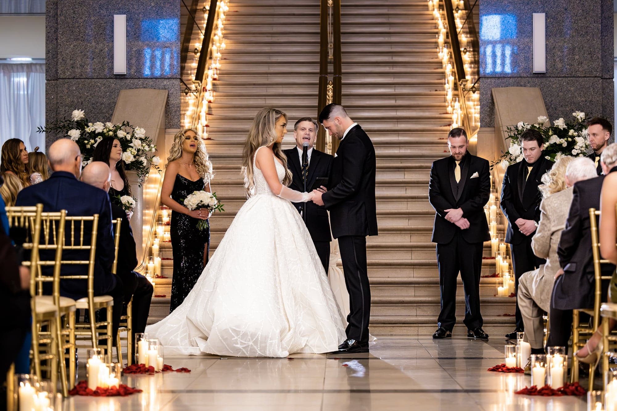 Katrinia and Dane leaving their ceremony through a joyful line of wedding guests