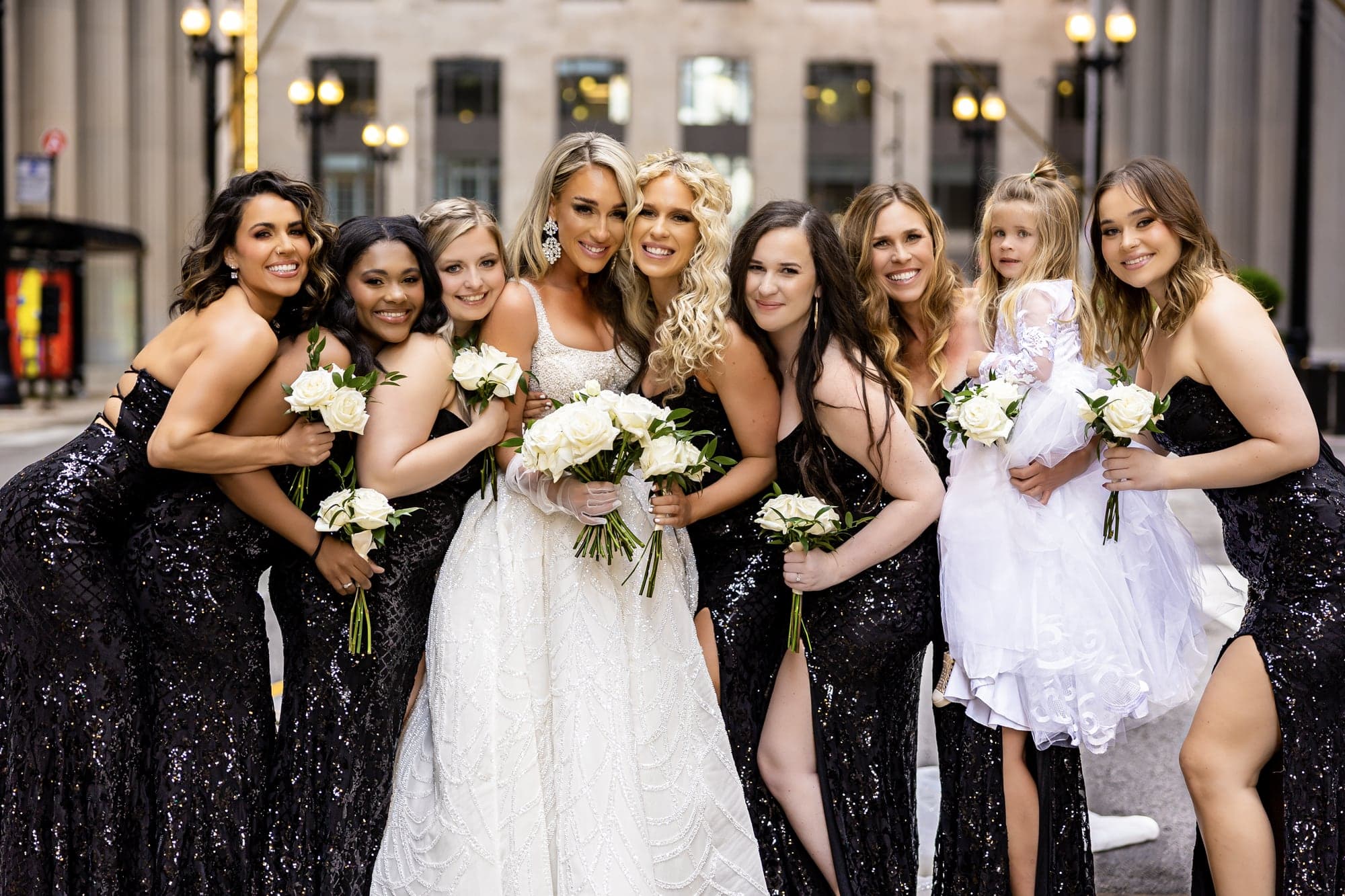Katrinia with her bridesmaids in black dresses on a downtown Chicago street