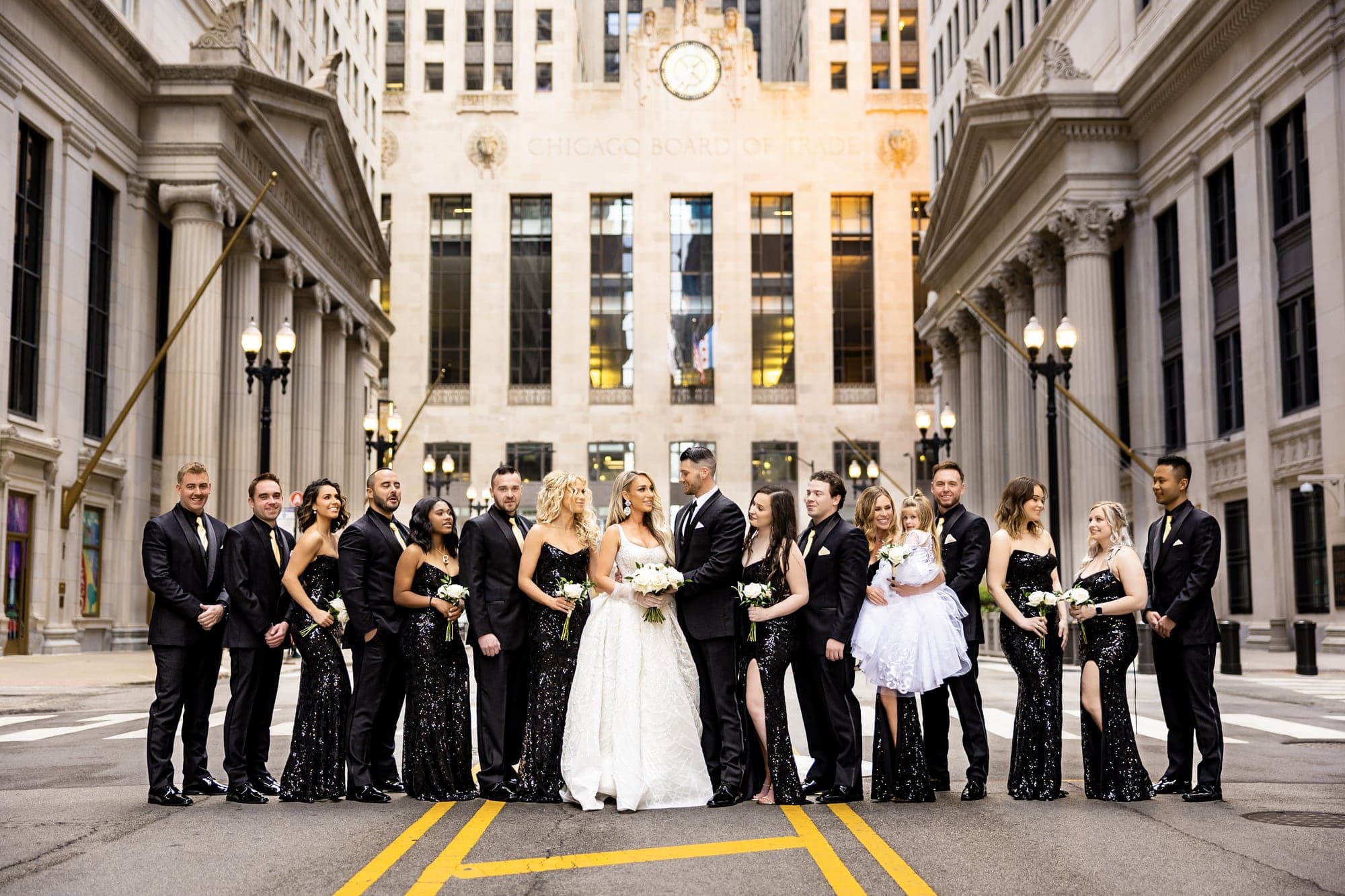 Katrinia and Dane's wedding party gathered between tall buildings in the Chicago Loop