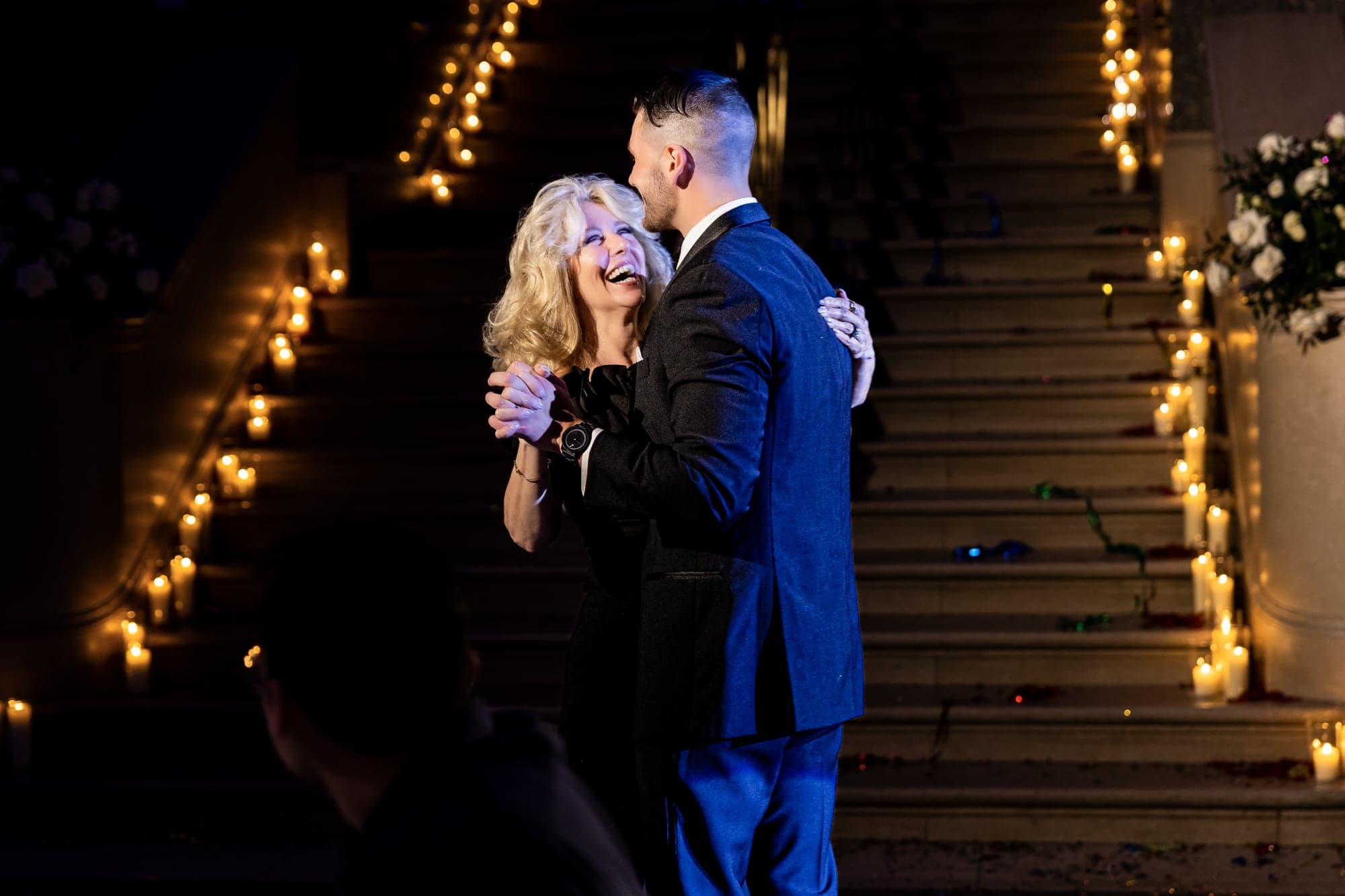 Katrinia and Dane sharing a dramatic nighttime portrait on the grand staircase