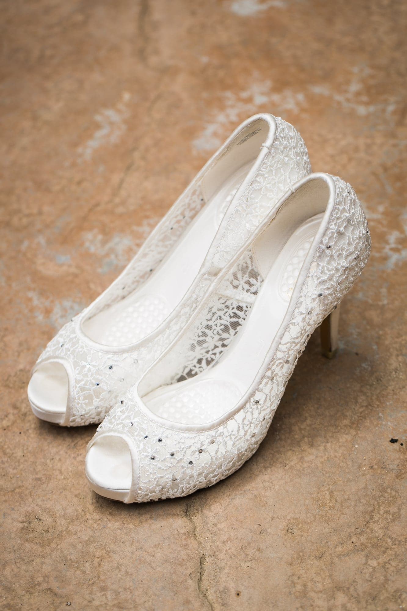 Lace wedding shoes before Krista and Oscar's ranch ceremony