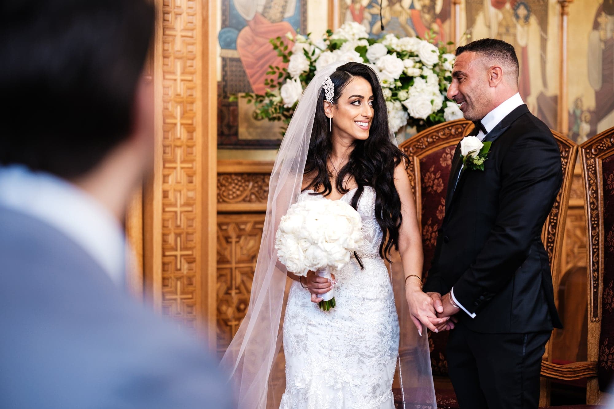 Vivian and Sherif standing together inside the richly decorated Coptic Orthodox church