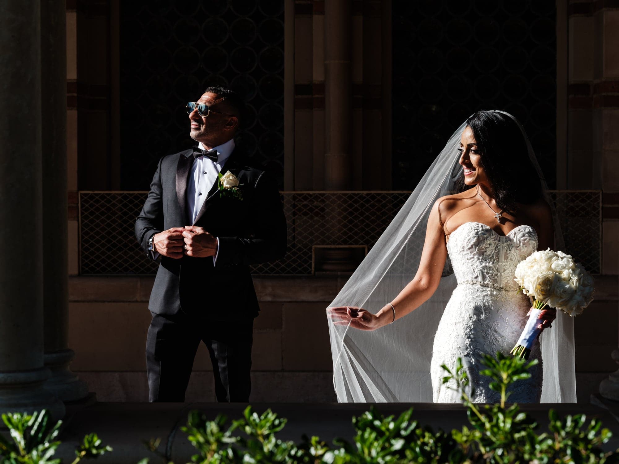 Vivian and Sherif framed by an architectural arch after their wedding ceremony