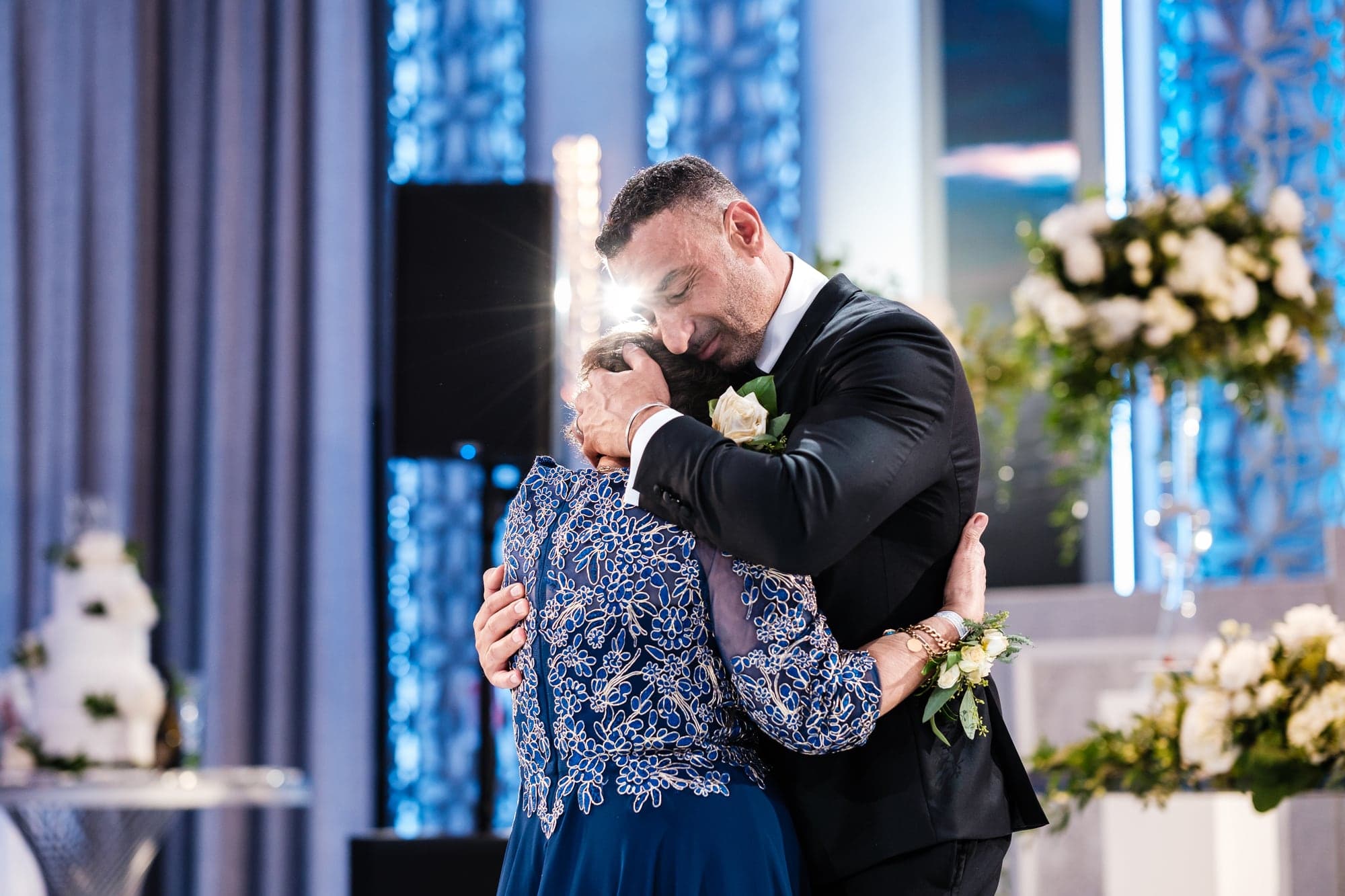 Sherif embracing a family member during an emotional reception moment