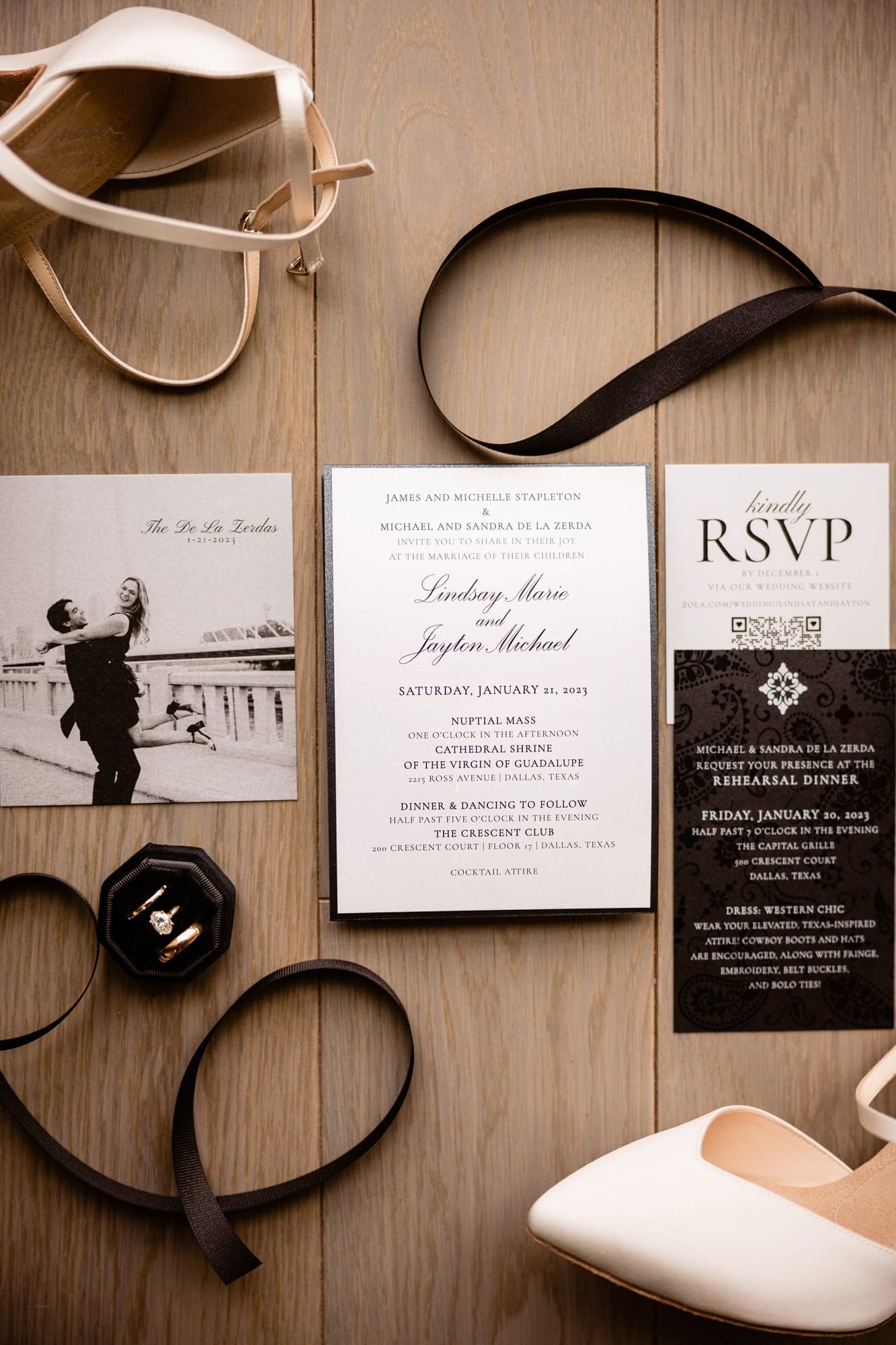 Lindsay and Jayton's rings and stationery arranged before their Crescent Club Dallas wedding