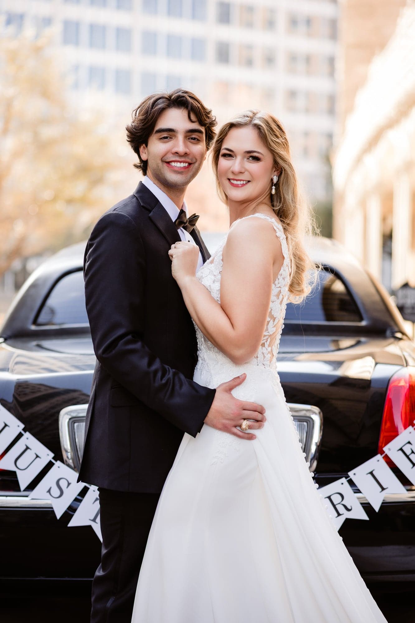 Lindsay and Jayton walking together through the Dallas Arts District after their ceremony