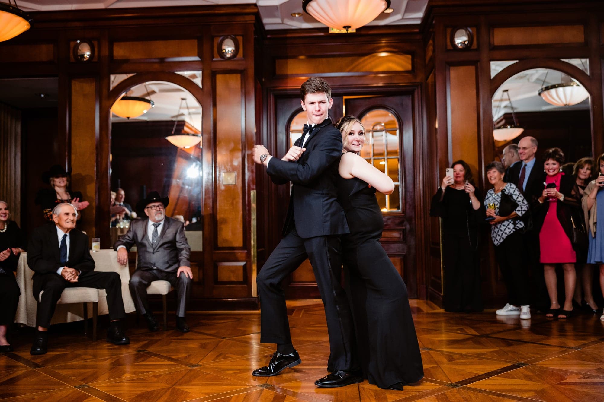Lindsay and Jayton dancing inside the warm wood-paneled Crescent Club