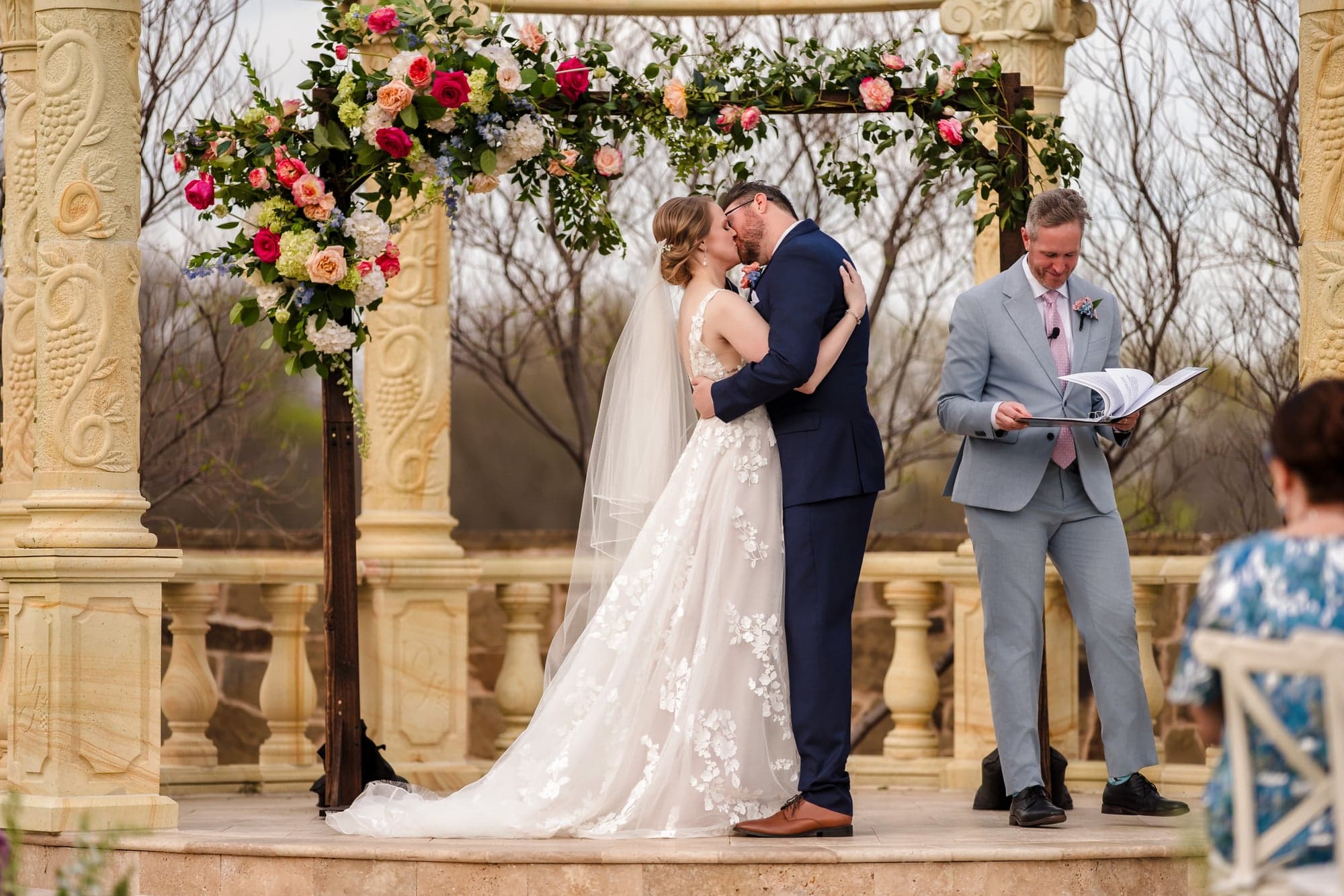 Erin and Hunter's first kiss beneath the floral-wrapped stone rotunda