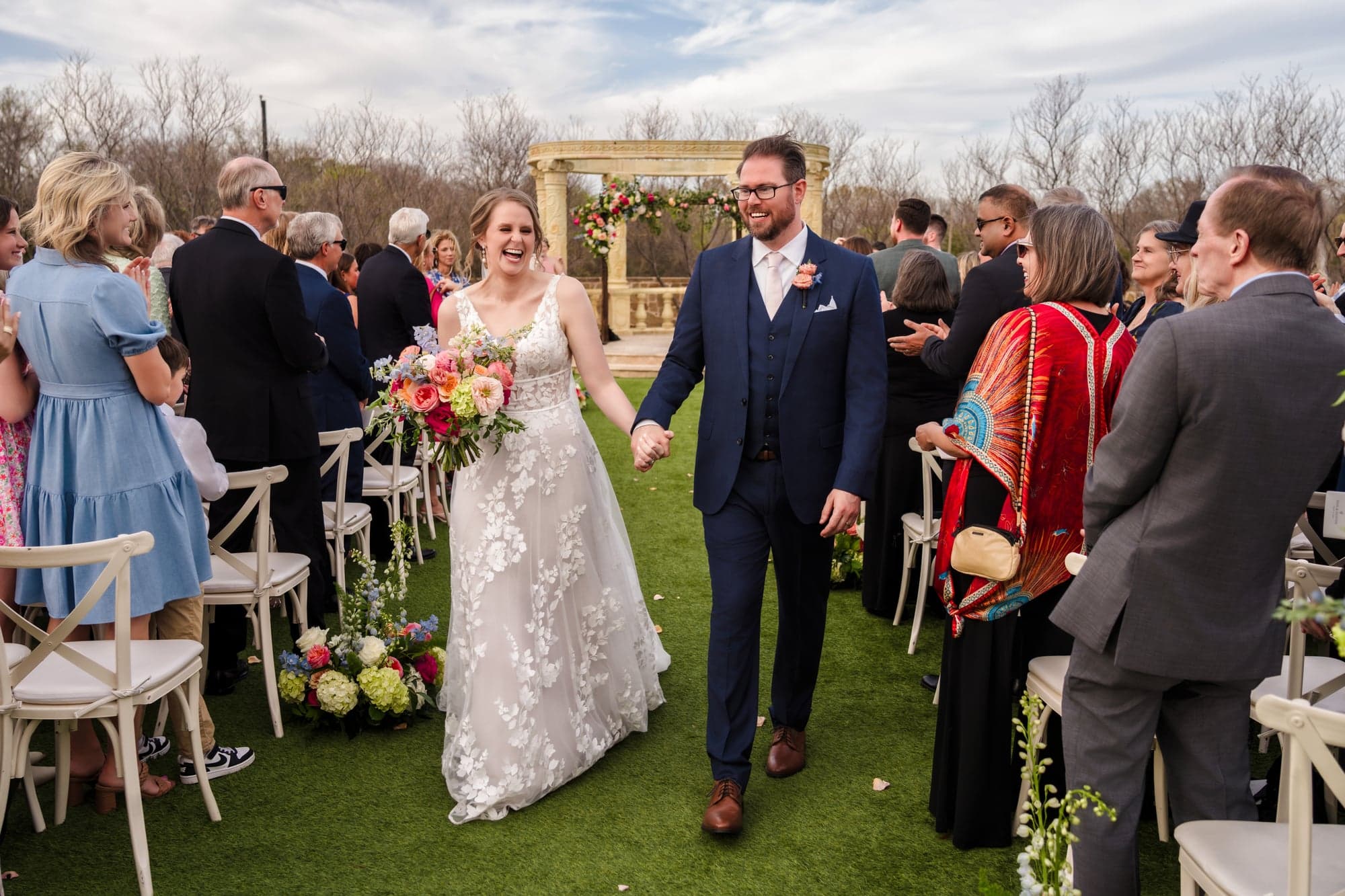 Erin and Hunter coming back up the aisle hand in hand as guests applaud