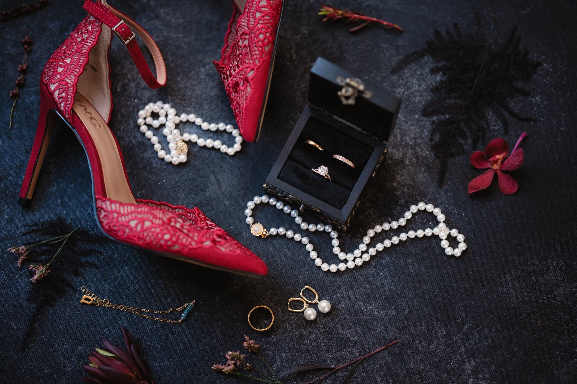 Alda and Kevin's red black and pearl wedding details