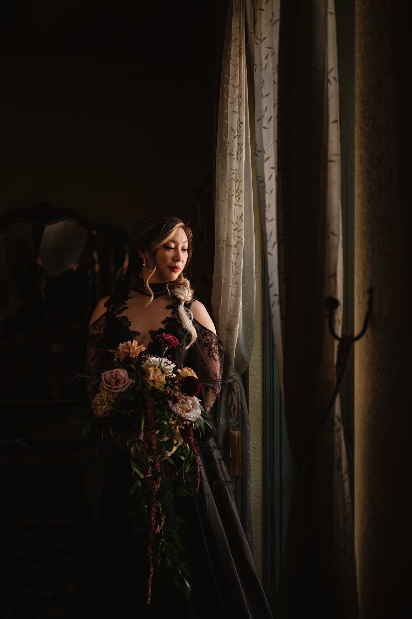 Alda holding a deep red bouquet inside The Ebell
