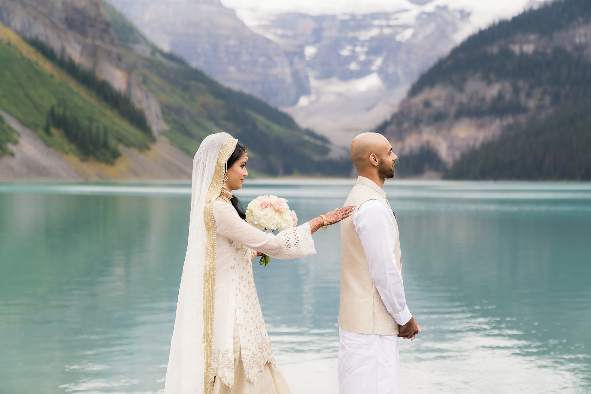 Lubna and Waqas with Lake Louise and the Canadian Rockies behind them