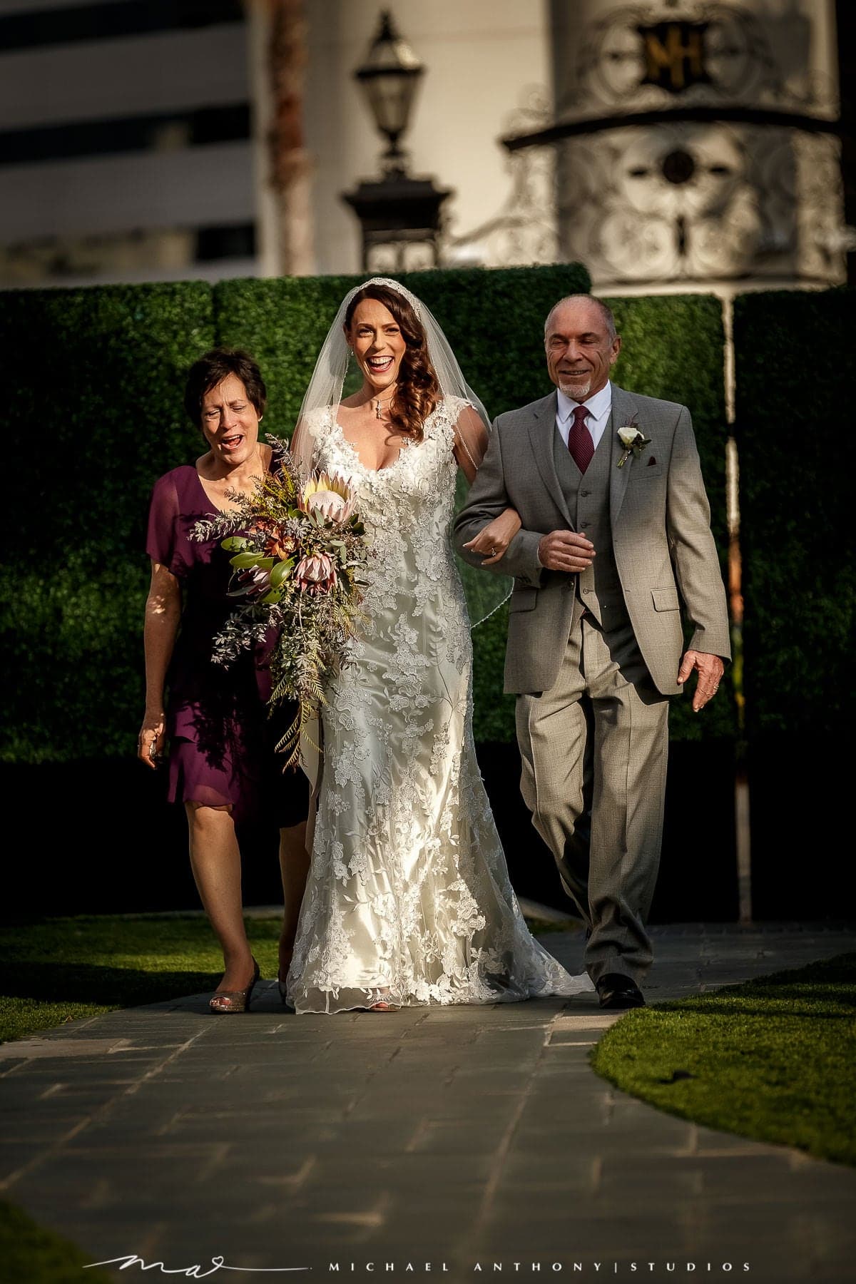 Melissa entering the Fairmont Miramar garden ceremony with her family