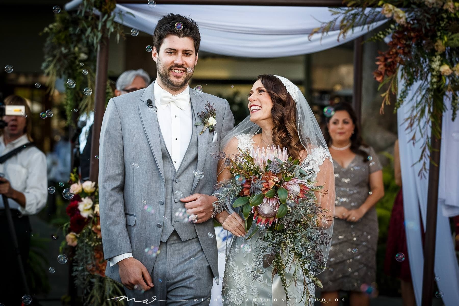 Melissa and Gary walking through bubbles after their ceremony