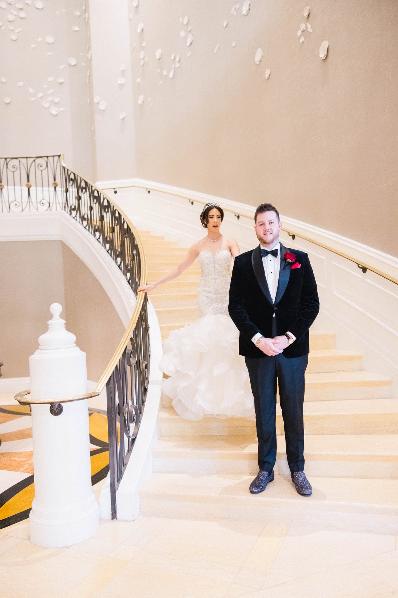 Jason waiting at the foot of the Four Seasons staircase as Kylie approaches for their first look