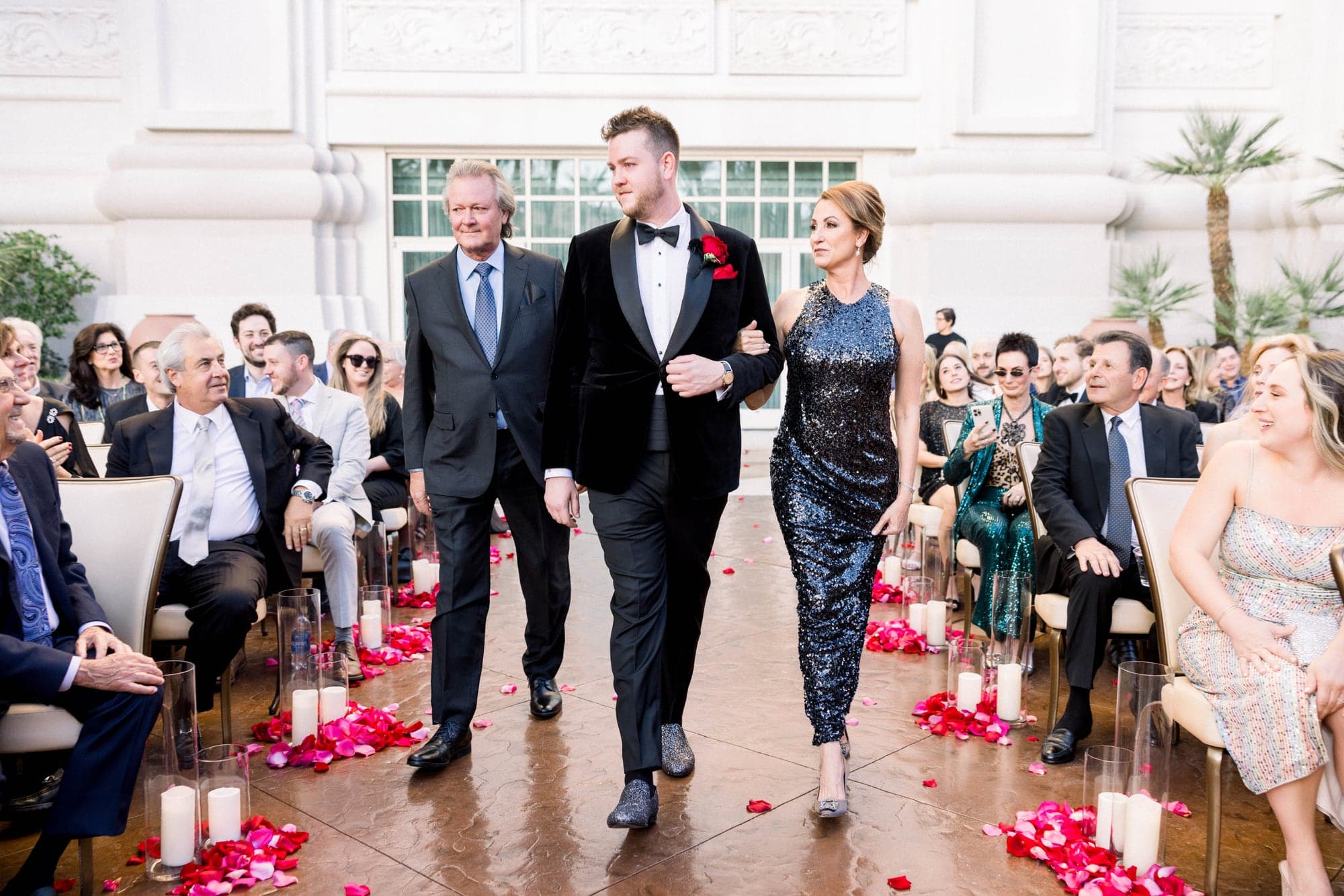Jason walking down the flower-lined outdoor aisle at Four Seasons Las Vegas