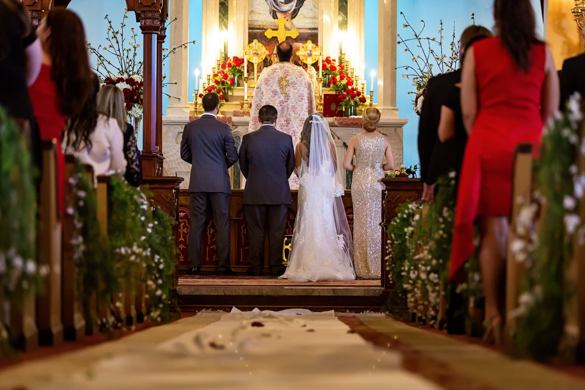 Angela and Arthur at the gilded altar of St. Mary's Armenian Apostolic Church in Glendale, garlands and red roses lining the pews