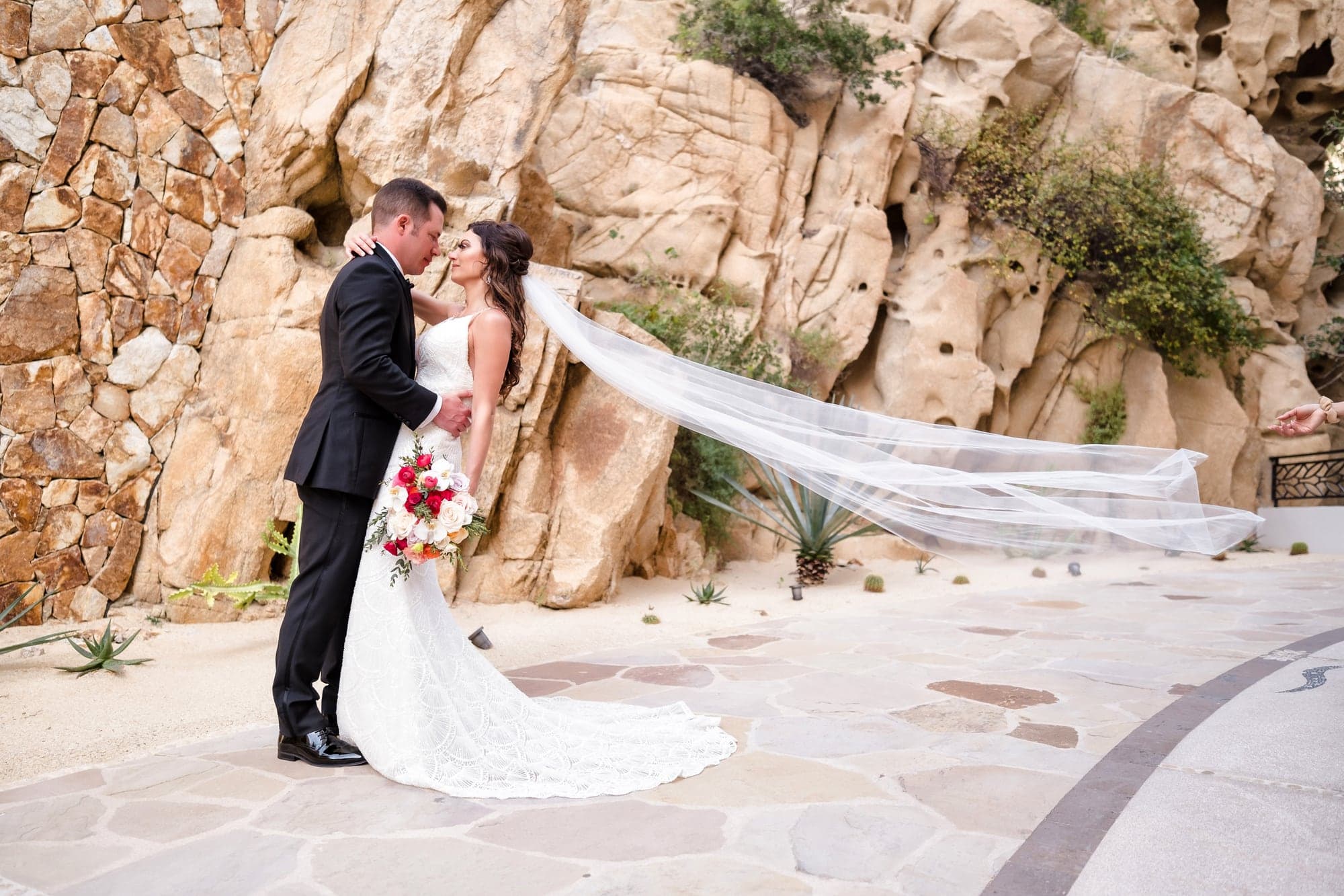 Tina and David standing together among the rock-lined passages at Grand Solmar