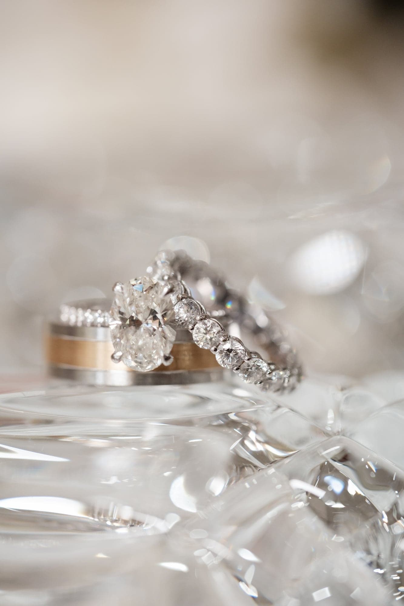 Eliz and Haig's wedding rings photographed against soft white flowers