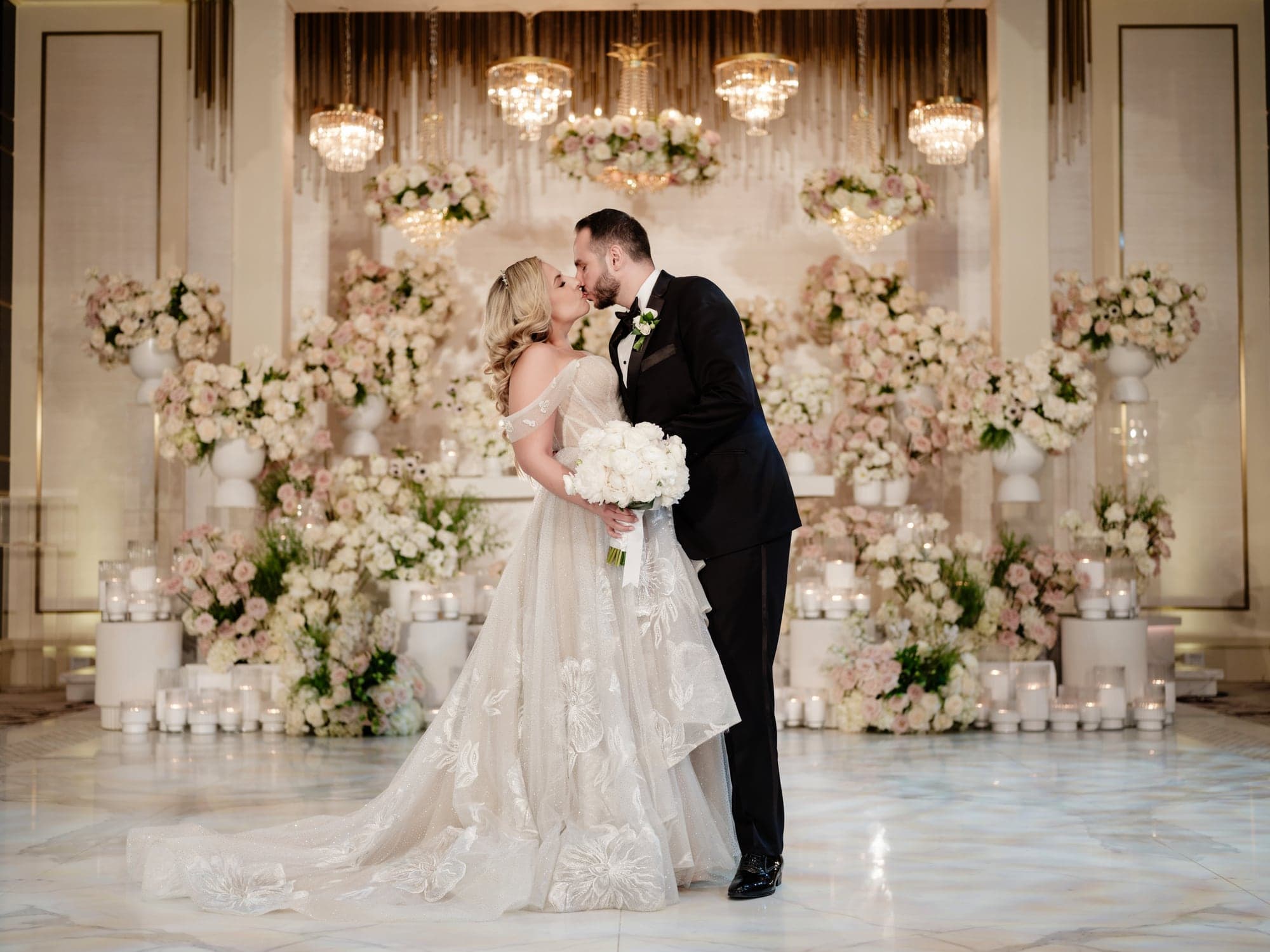 Eliz and Haig together before a flower-filled sweetheart table at Grand Venue