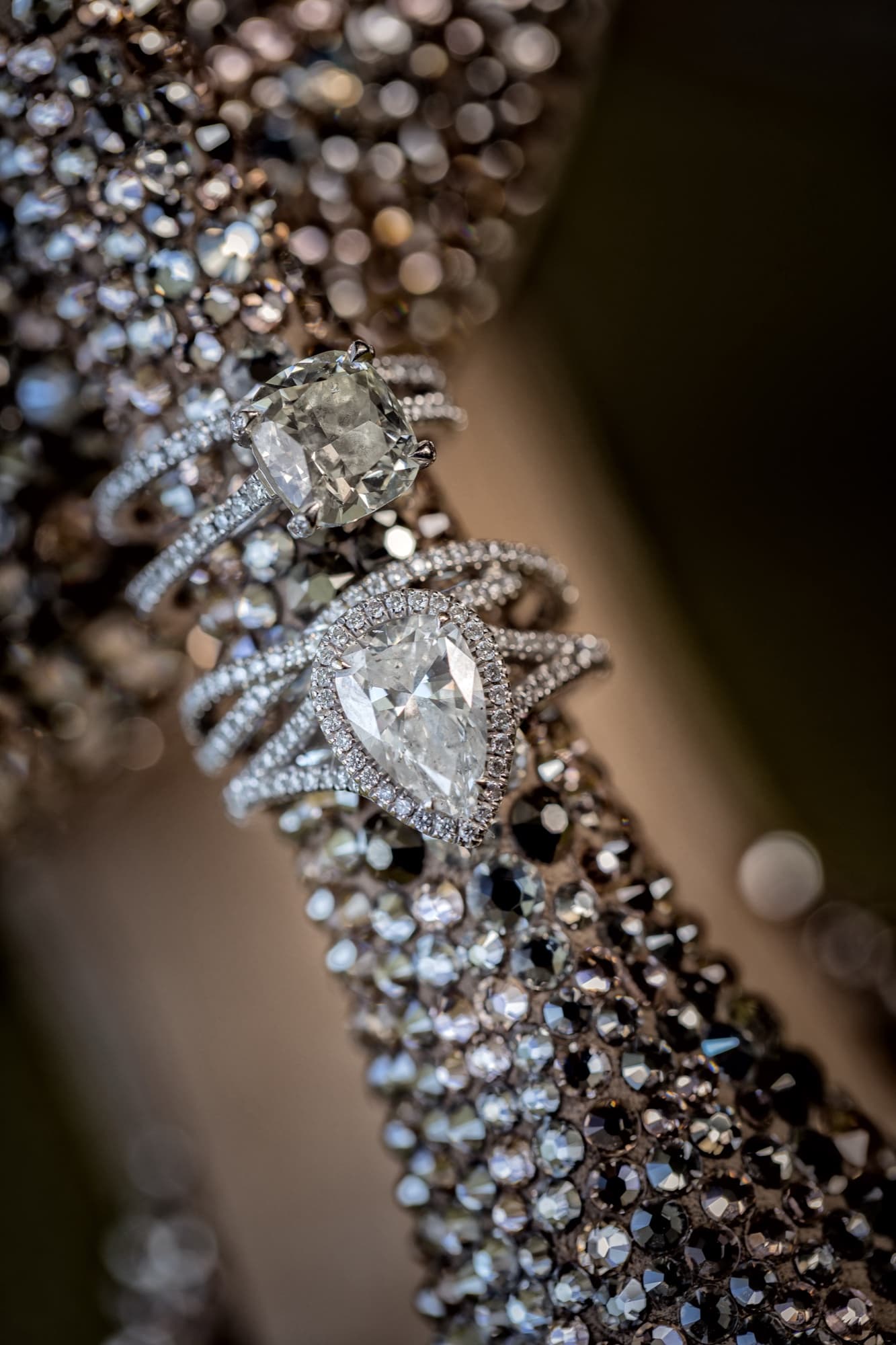 Amanda and Shauna's engagement rings and diamond bands nestled in a crystal-beaded clutch