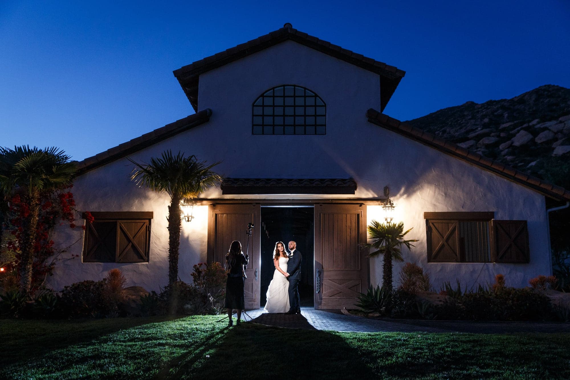 Jaqui and Brandon outside the illuminated hacienda