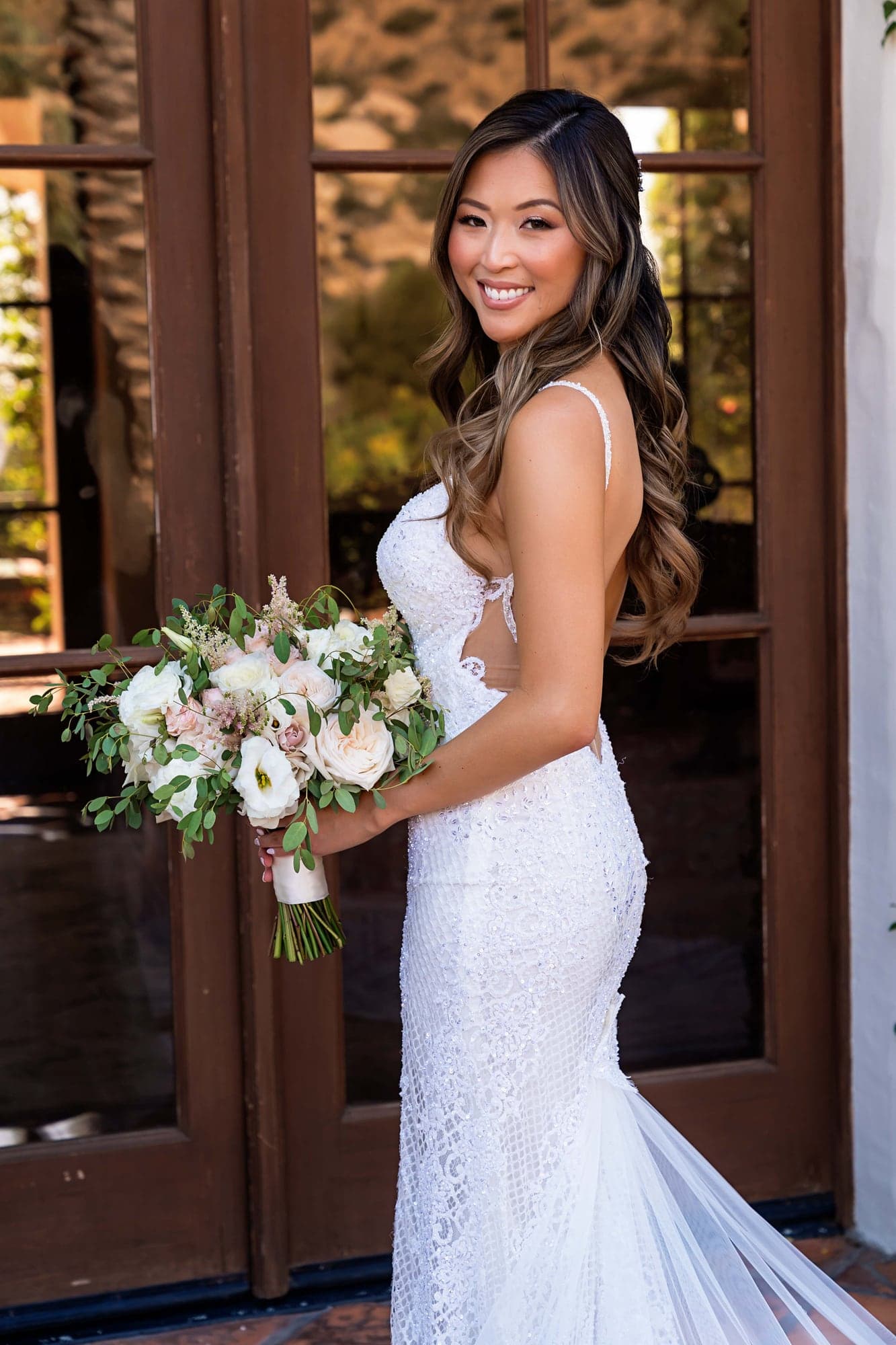 Stephanie holding a blush and white bridal bouquet