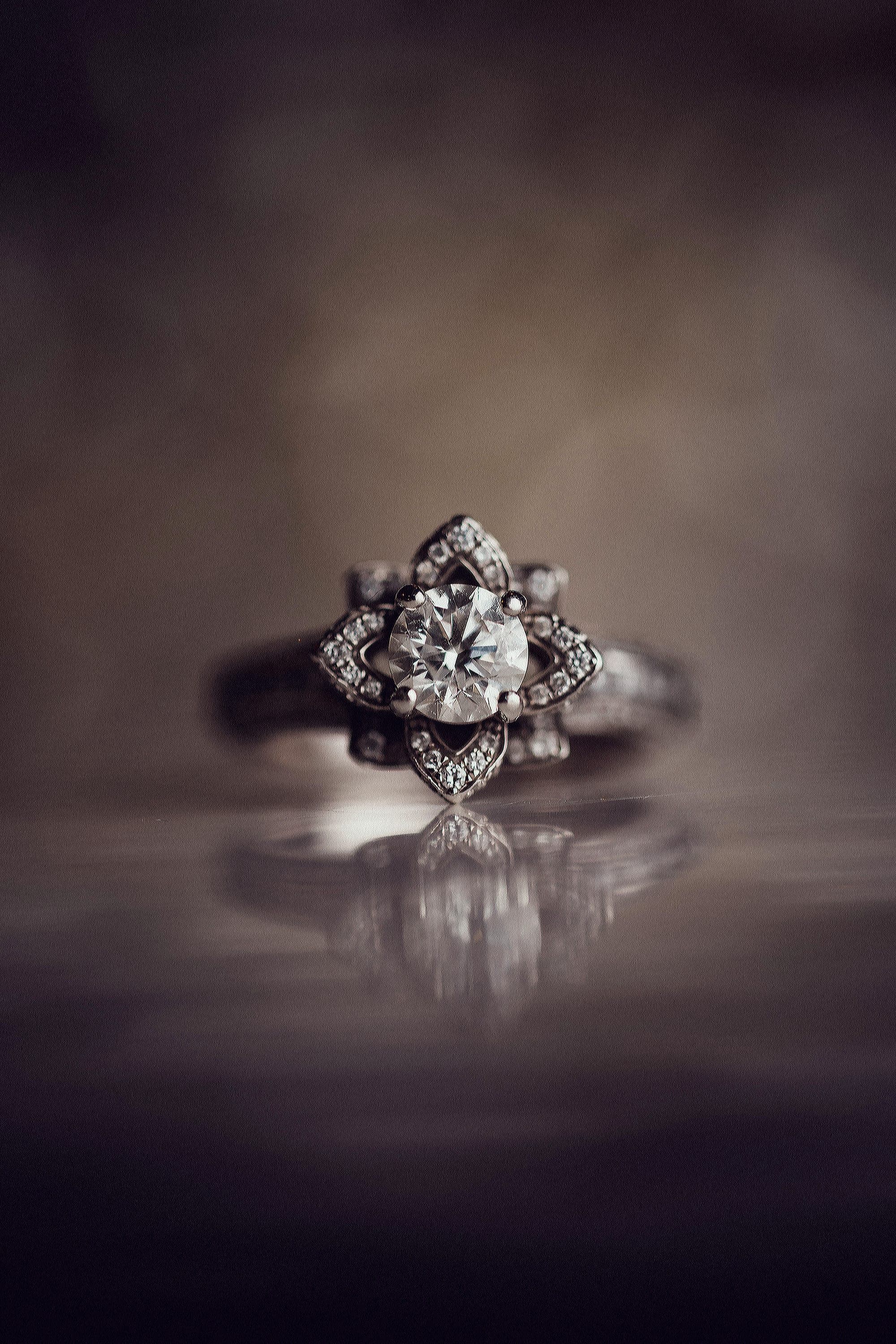Carly's ring standing on a dark reflective surface