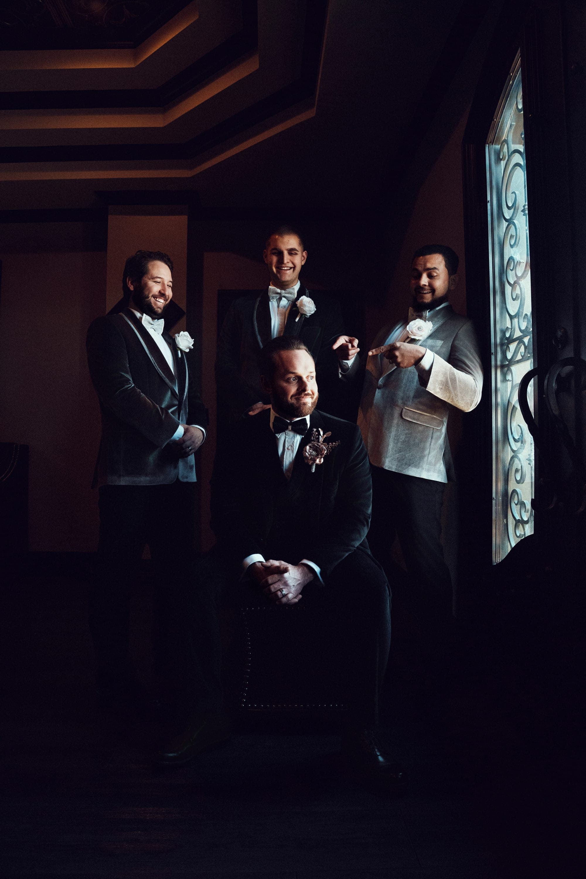 Christopher and his groomsmen in the doorway light at Knotting Hill Place