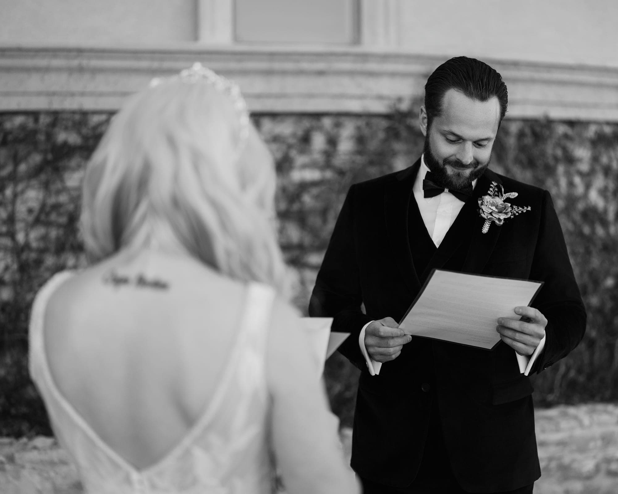 Black and white photograph of Carly and Christopher reading their private vows