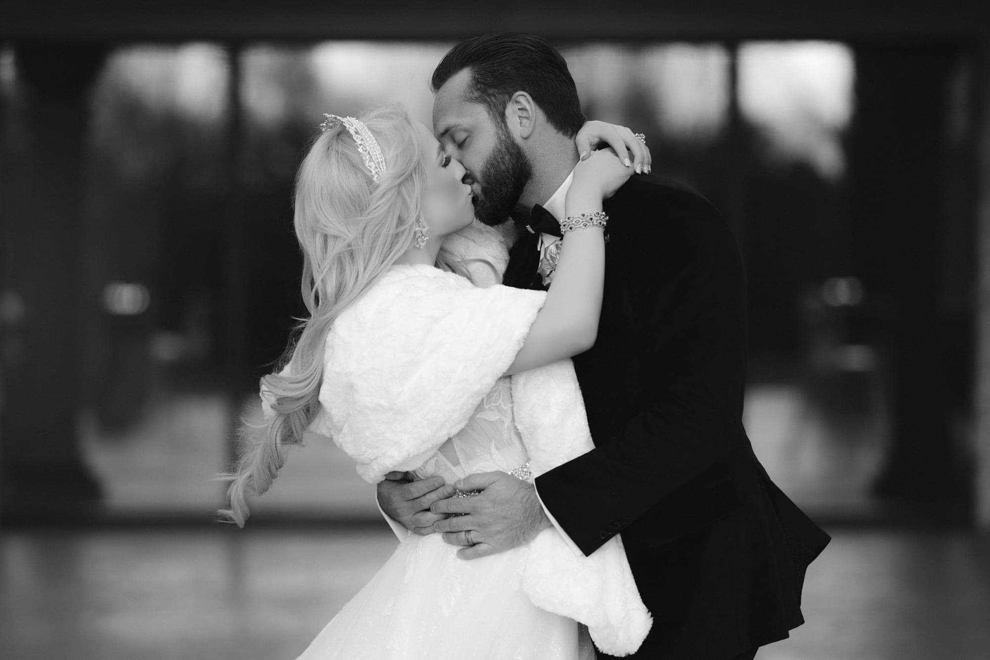 Black and white photograph of Christopher dipping Carly for a kiss