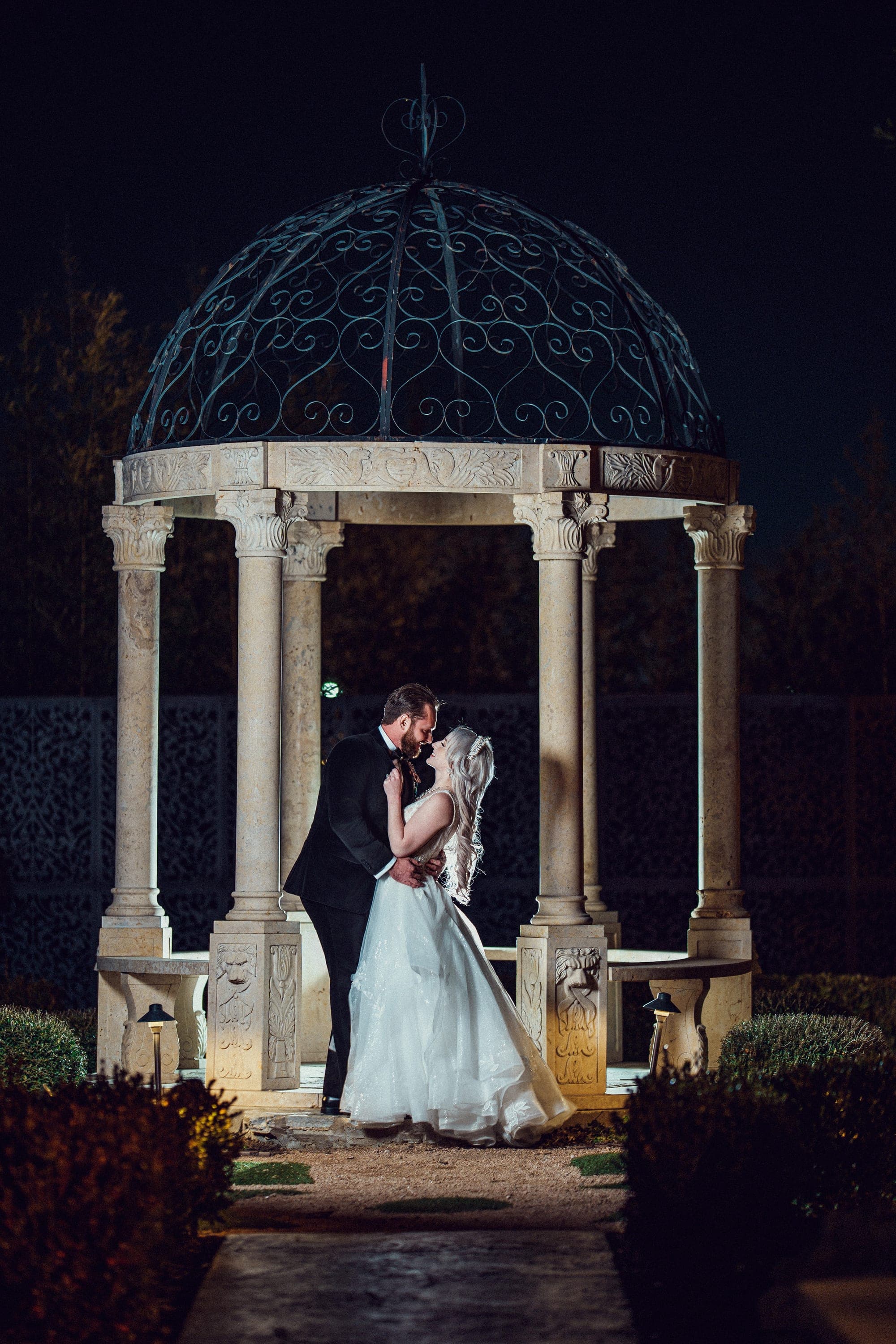 A night kiss beneath the stone gazebo in the gardens