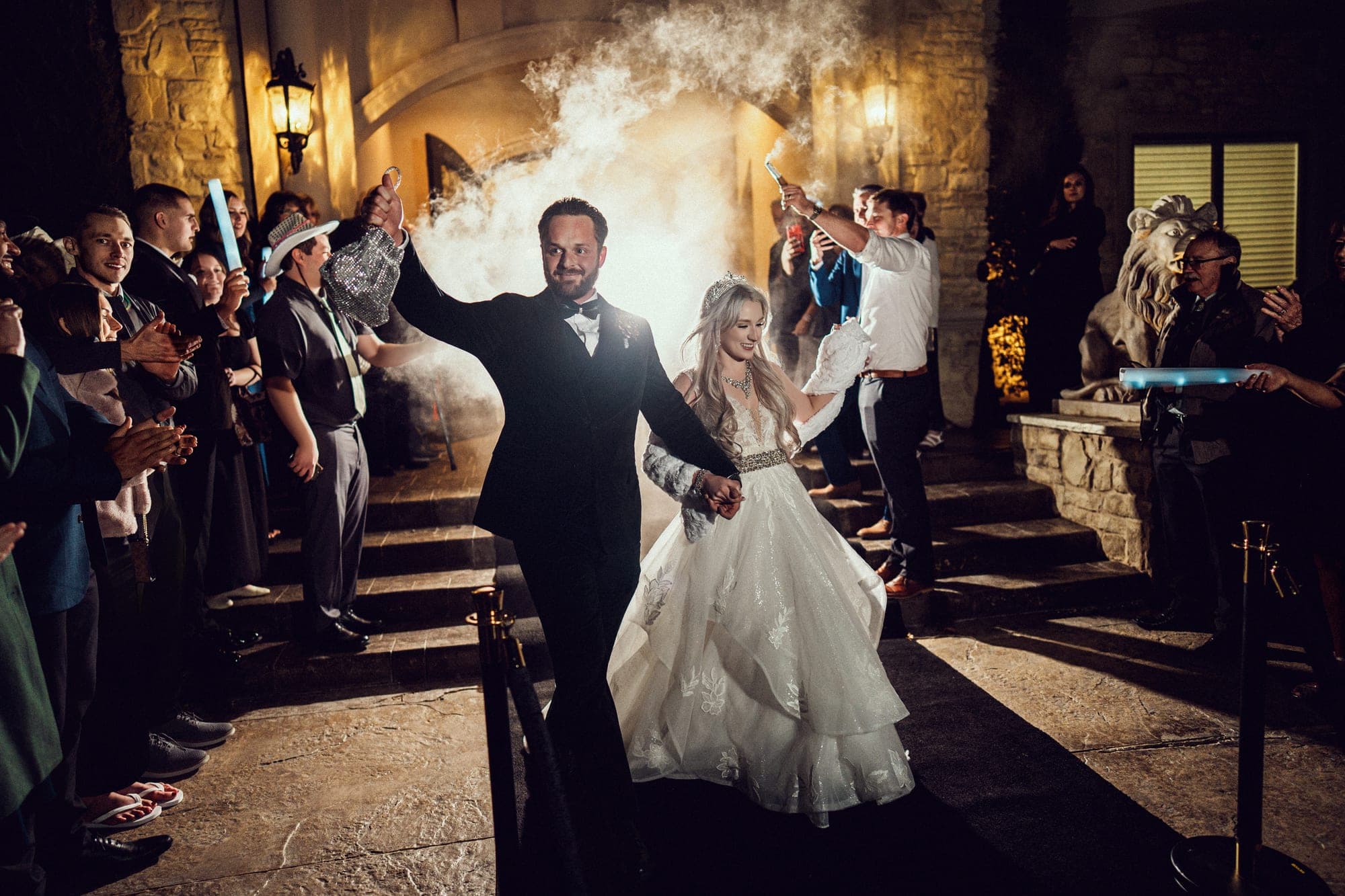 Carly and Christopher's send-off through smoke and sparklers on the stone steps