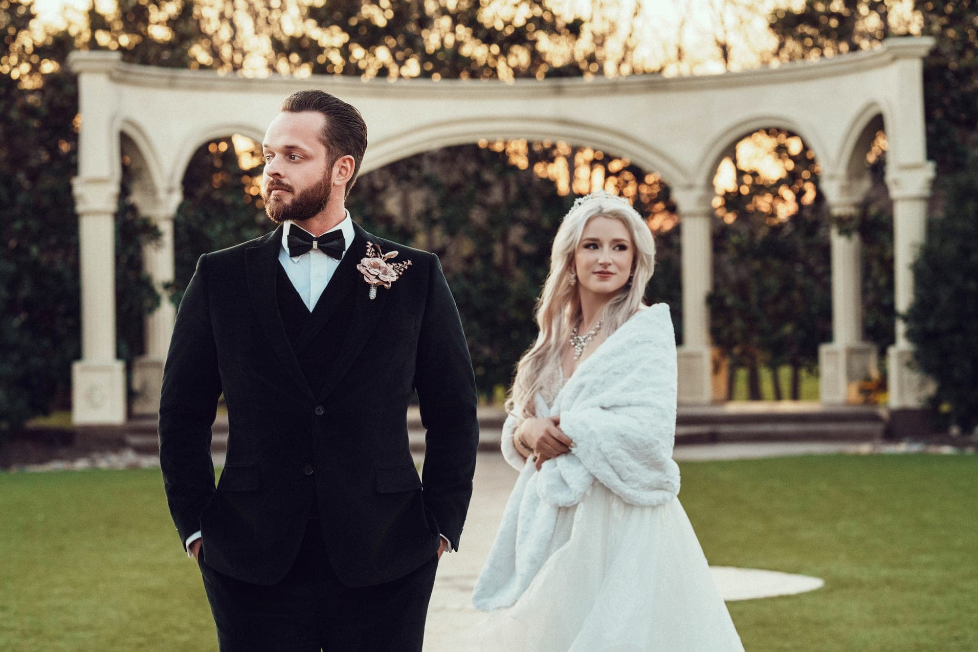 Newlyweds beneath the garden colonnade at Knotting Hill Place in Little Elm at sunset