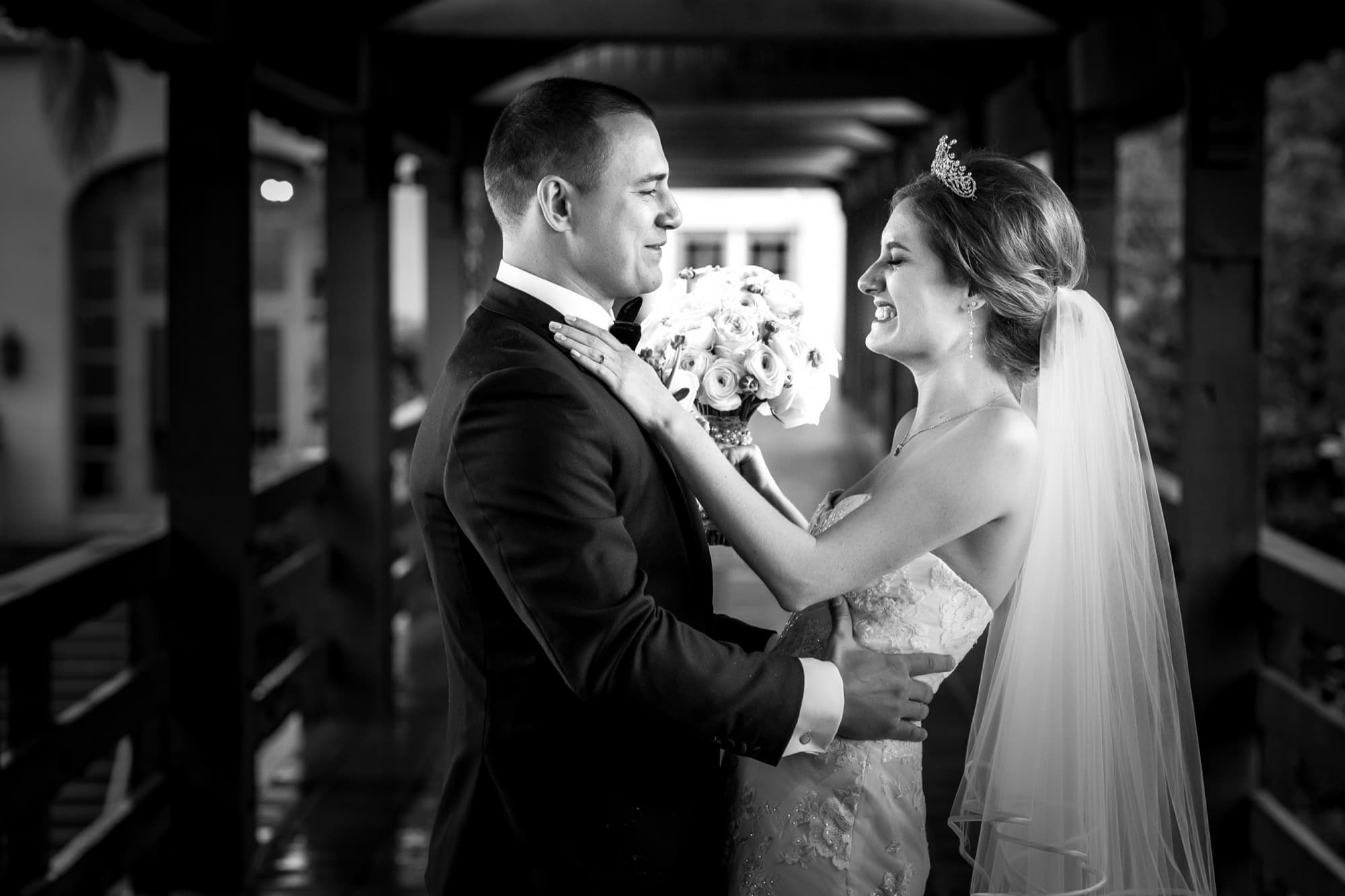 Black and white portrait of Ilana in a tiara and veil embracing Christopher at the Langham Pasadena