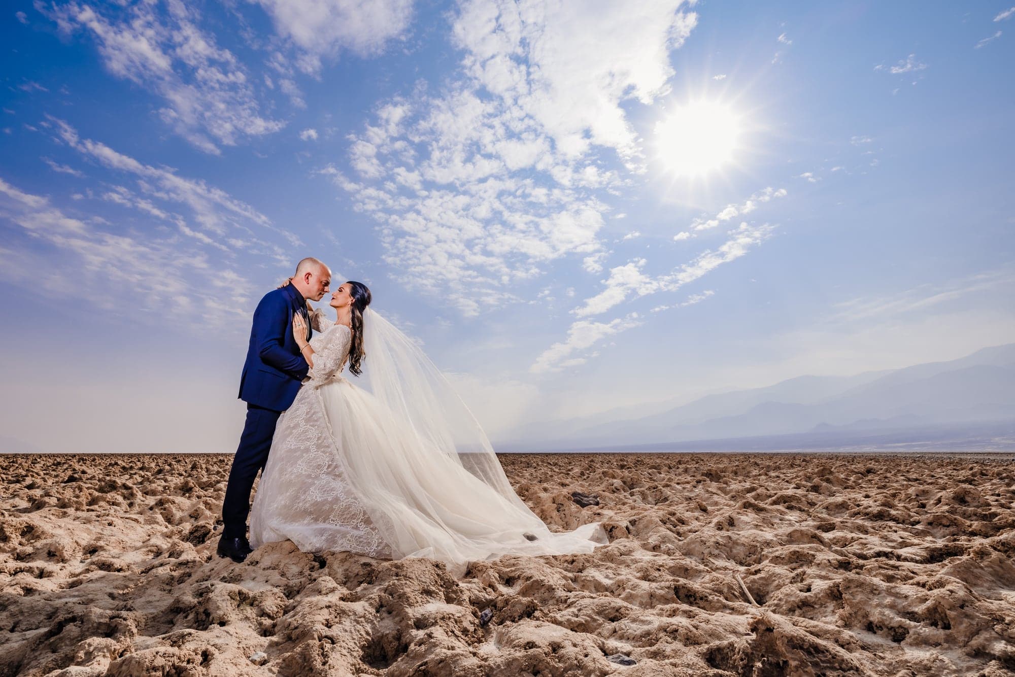 Wedding couple beneath the bright desert sky