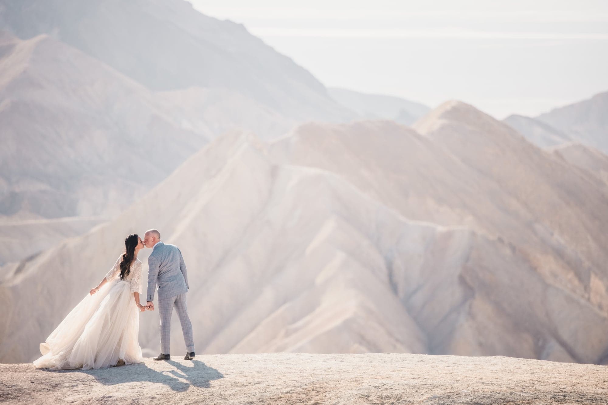 Wedding couple among pale desert formations